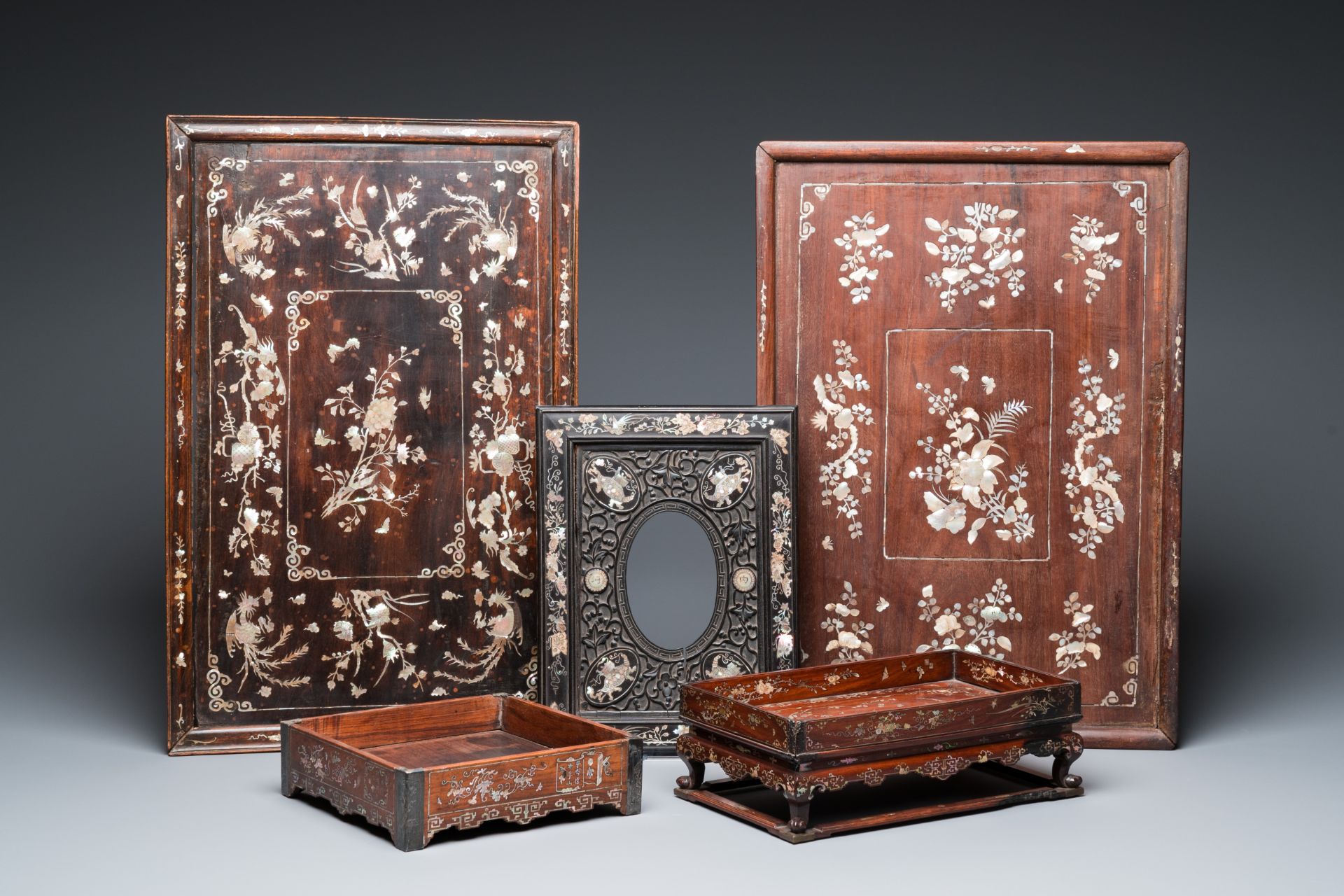 Two mother-of-pearl-inlaid wooden trays, two opium trays and an oval frame, China and/or Vietnam, 19
