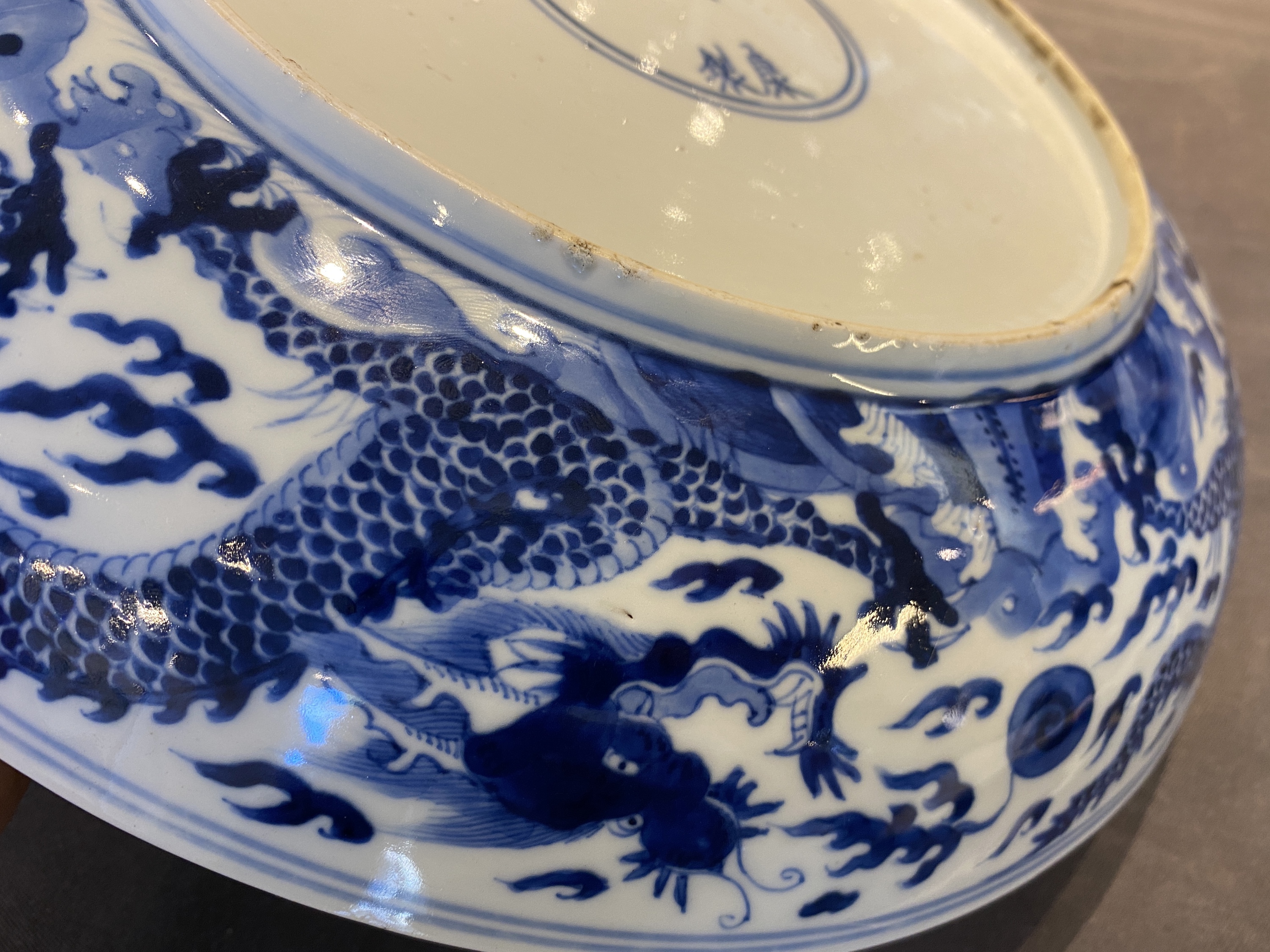 A Chinese blue and white 'dragon' dish, Kangxi mark and of the period - Image 11 of 18