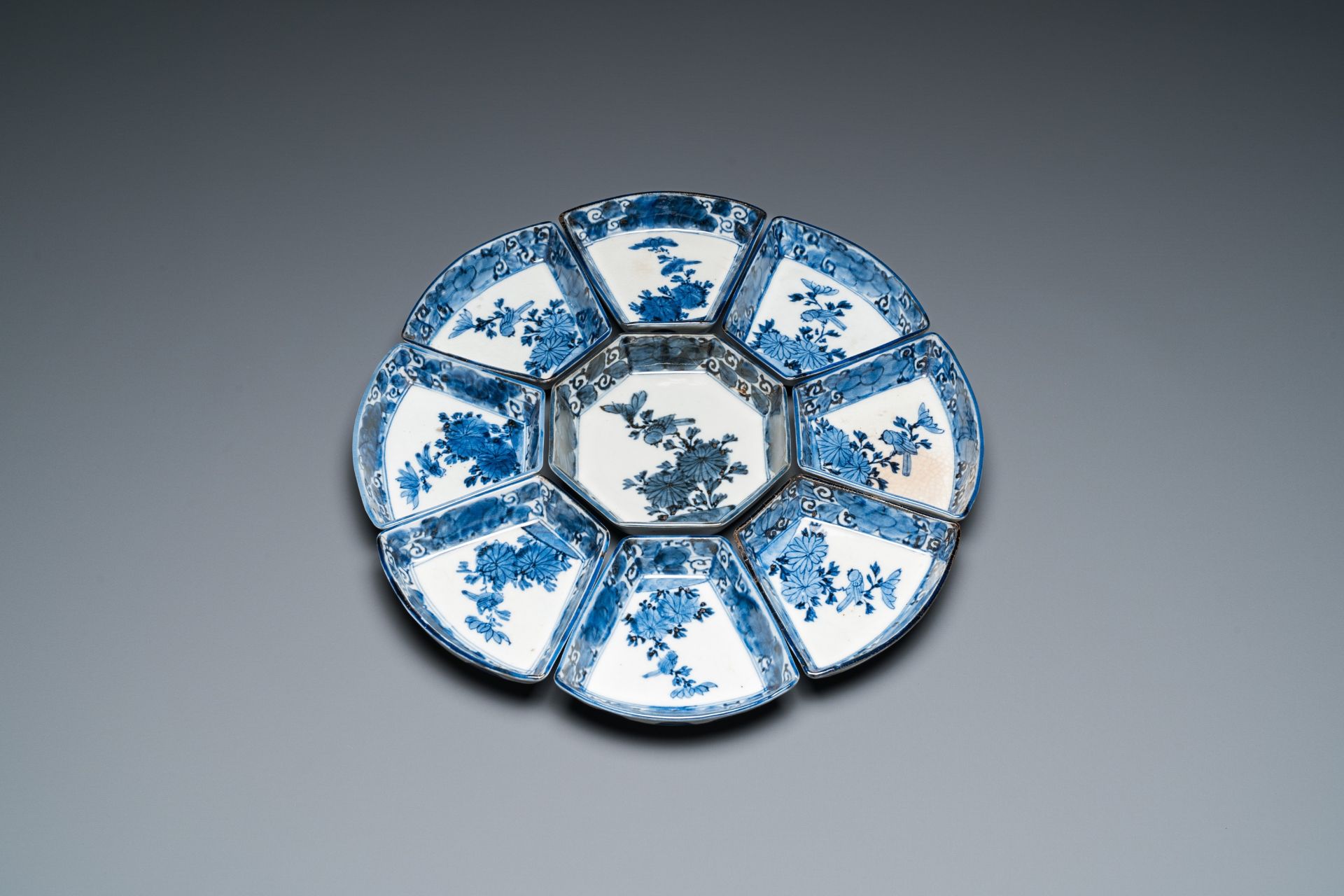 A blue and white Japanese Arita nine-piece sweetmeat set in its original lacquer box, Edo, 17/18th C