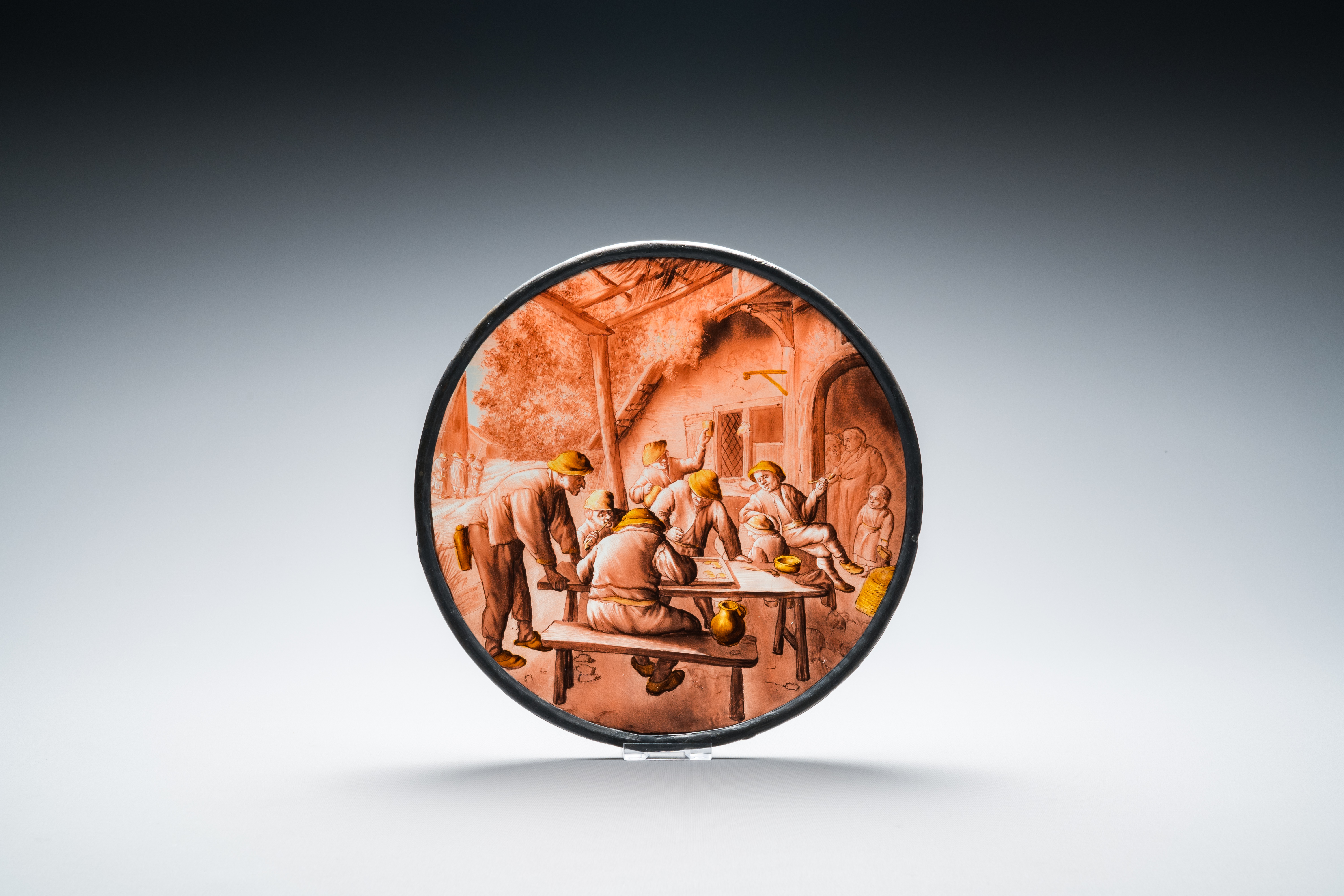 A painted glass roundel with 'The Backgammon-players' after Adriaen van Ostade, Southern Netherlands