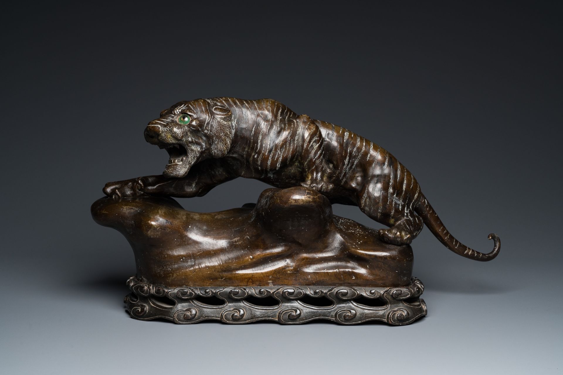 A large Vietnamese bronze tiger on a carved wooden stand, 19/20th C. - Image 2 of 10