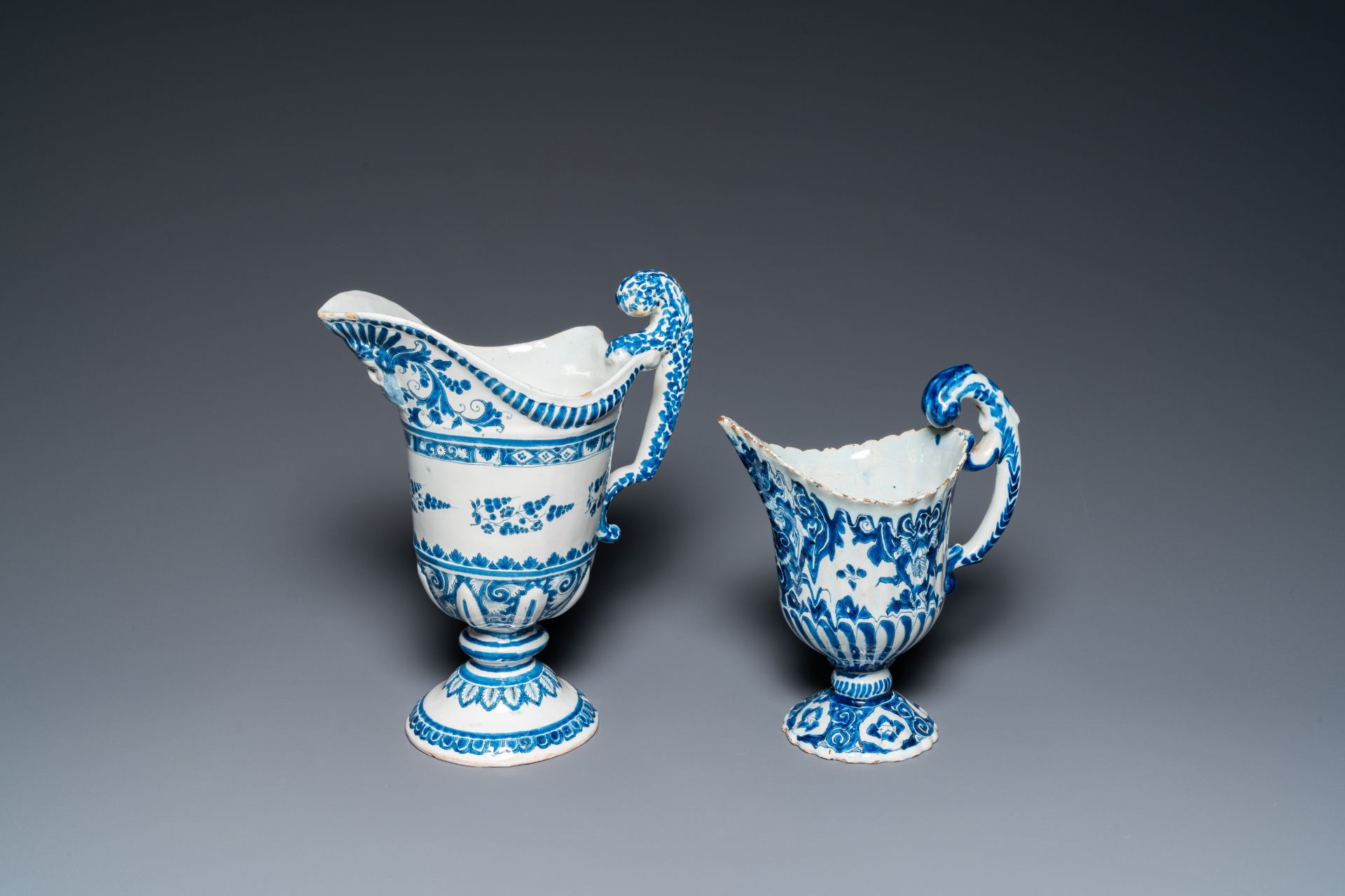 Two blue and white French faience helmet-shaped jugs, Rouen and Nevers, 18th C.