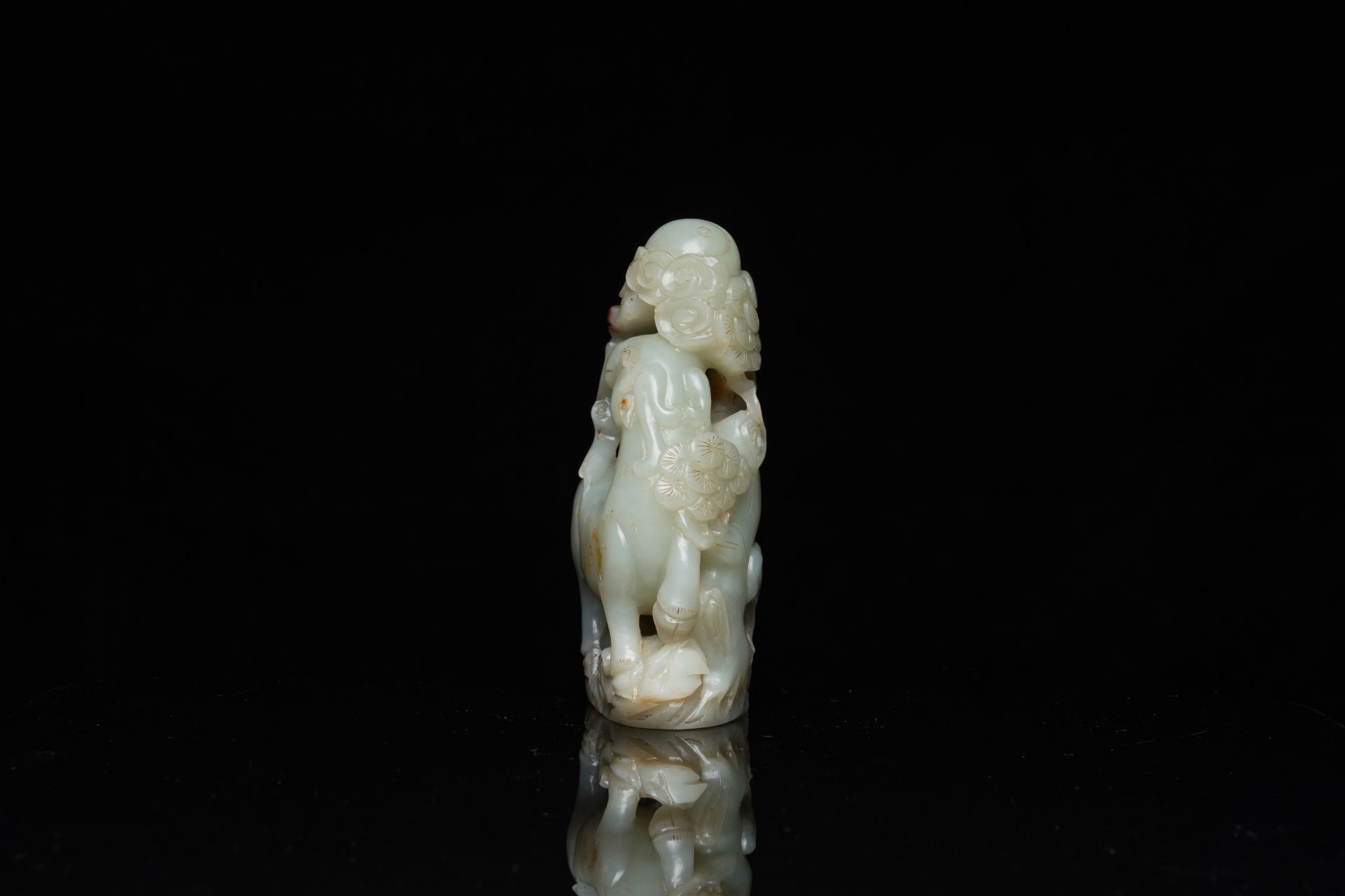 A Chinese celadon and russet jade ram sculpture on wooden stand, 19th C. - Image 3 of 18