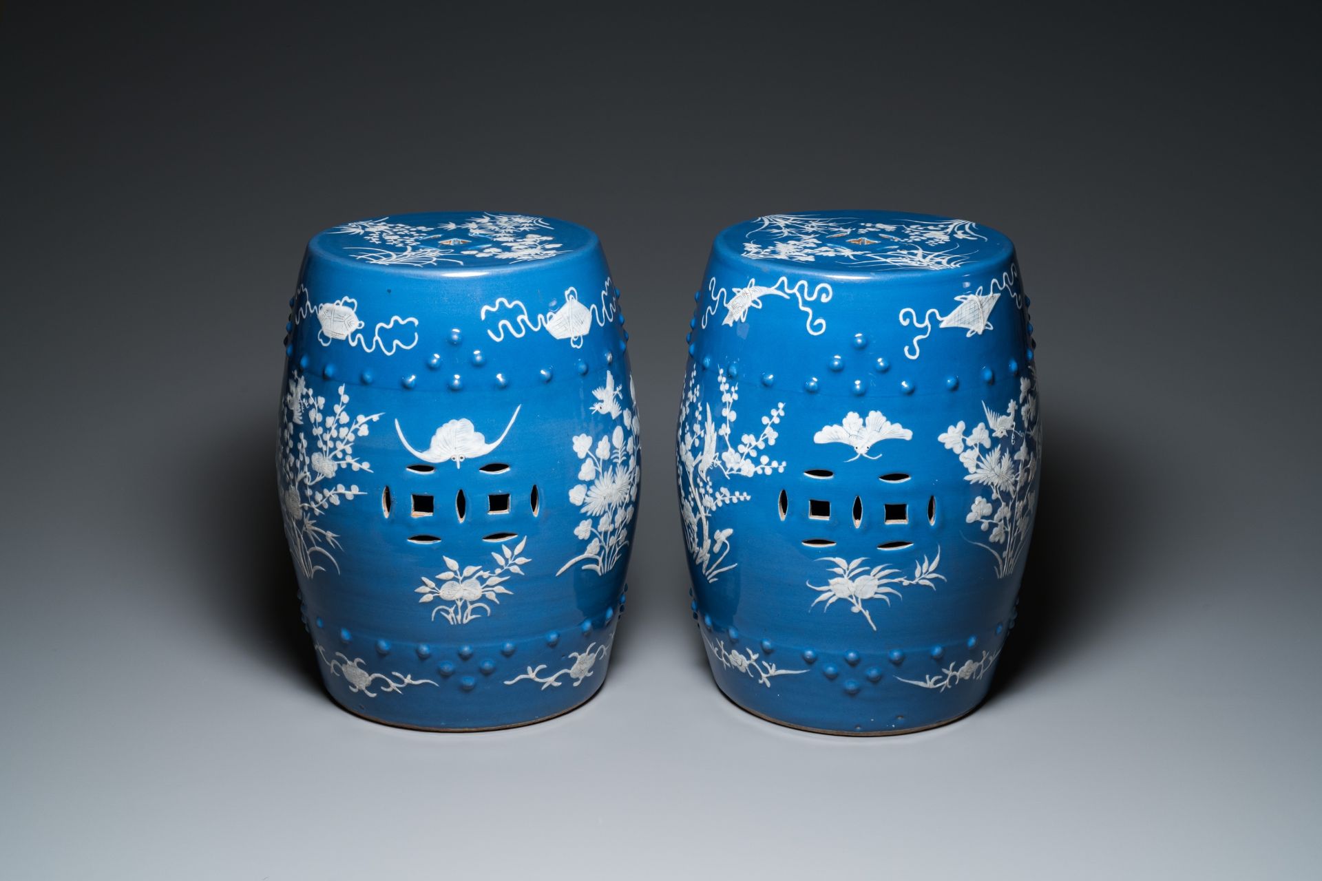 A pair of Chinese white slip-decorated blue-ground garden seats, 19th C.