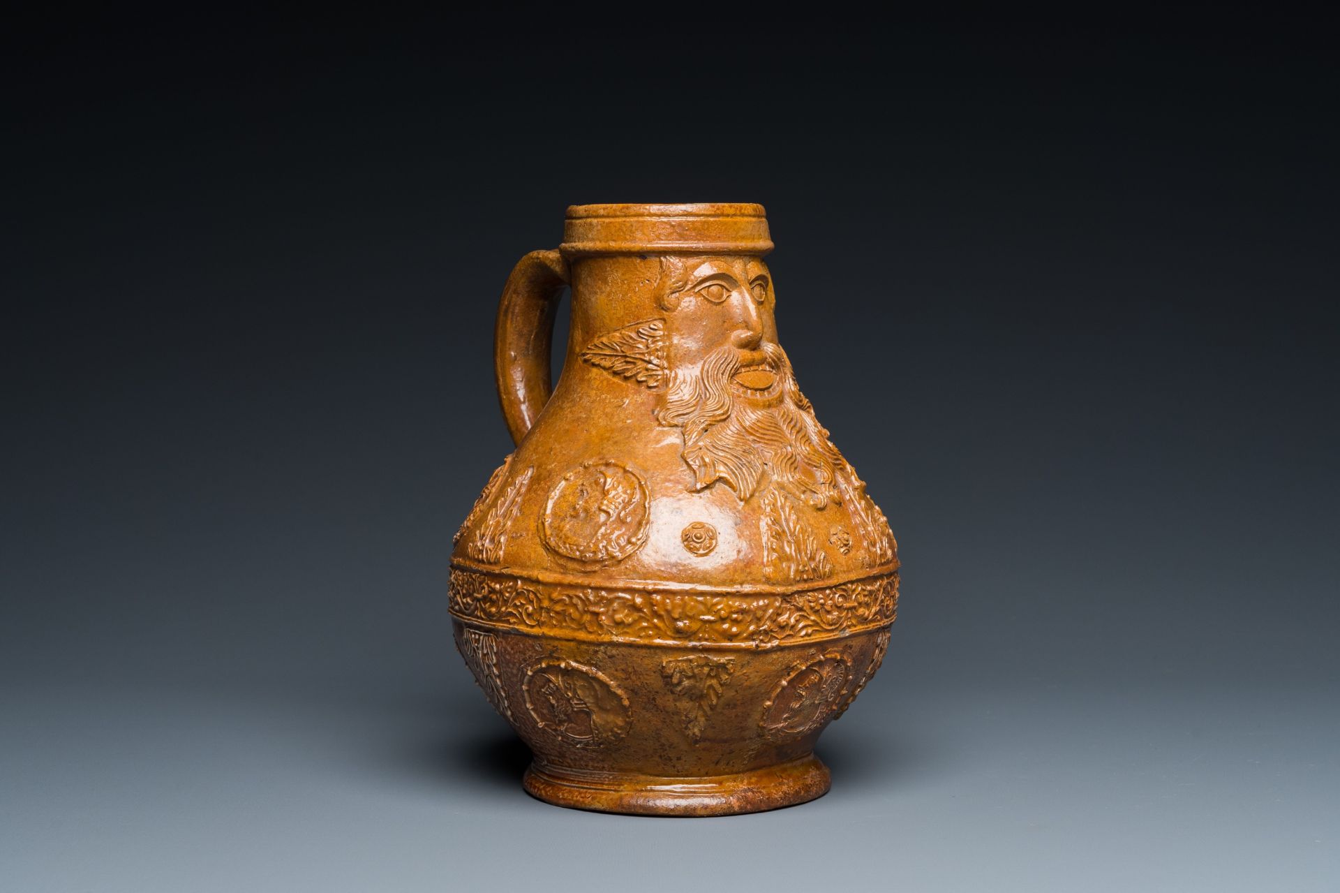 A rare German stoneware bellarmine jug with a bearded face sticking his tongue out, Cologne, 16th C. - Image 8 of 10