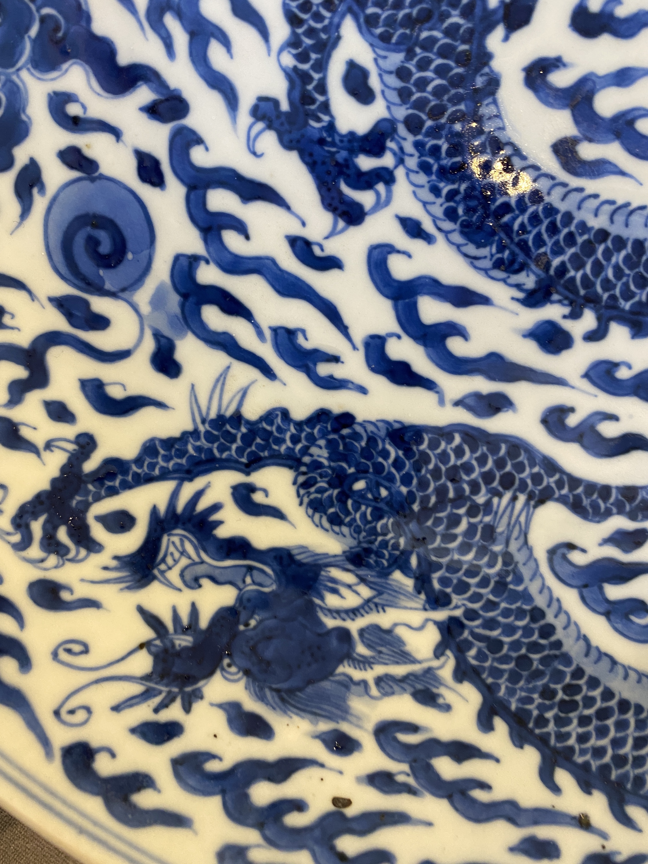 A Chinese blue and white 'dragon' dish, Kangxi mark and of the period - Image 6 of 18