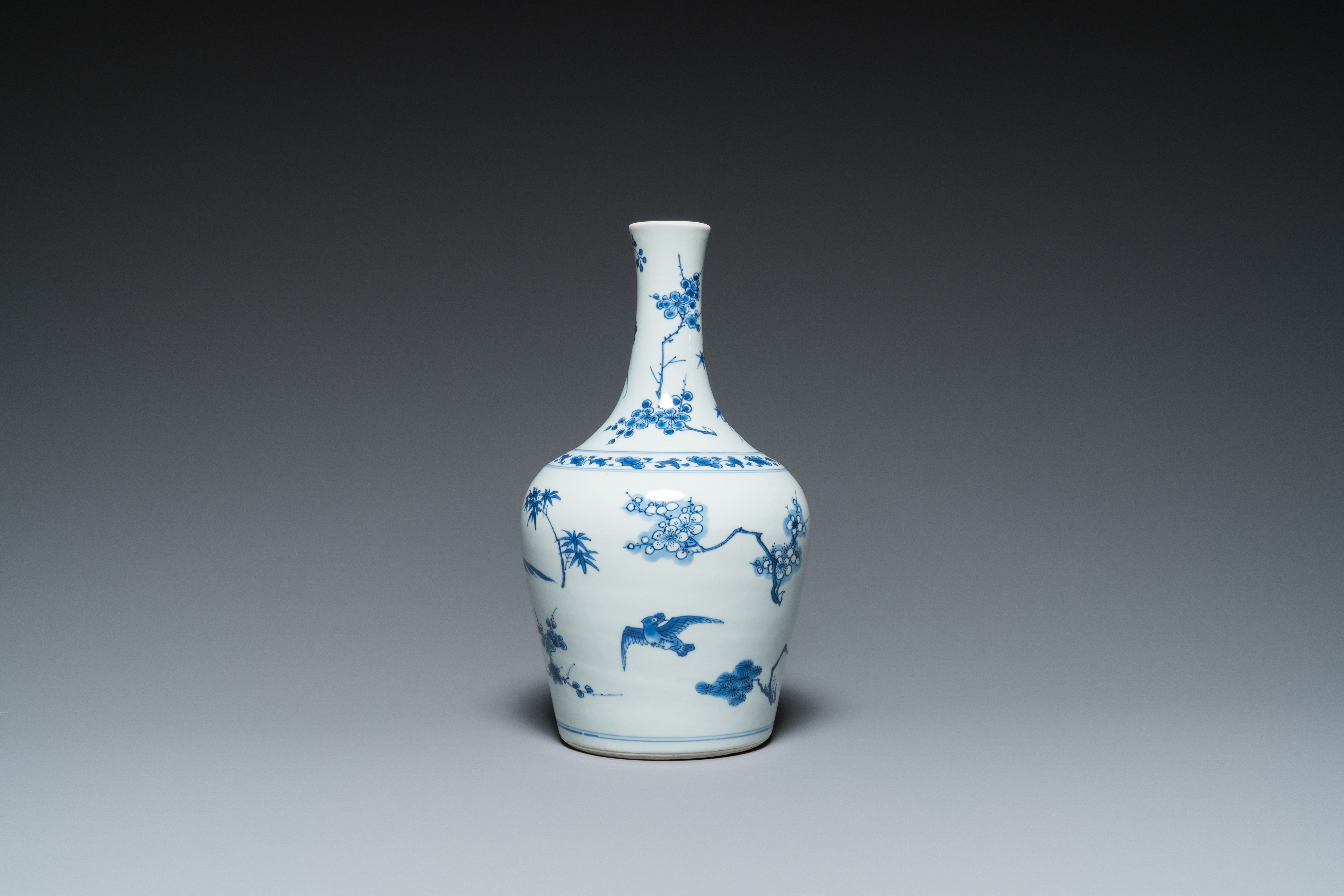 A Chinese blue and white bottle vase with birds among blossoms, Transitional period