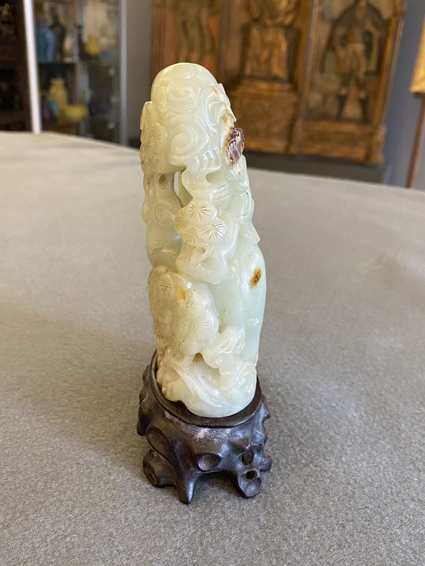 A Chinese celadon and russet jade ram sculpture on wooden stand, 19th C. - Image 11 of 18