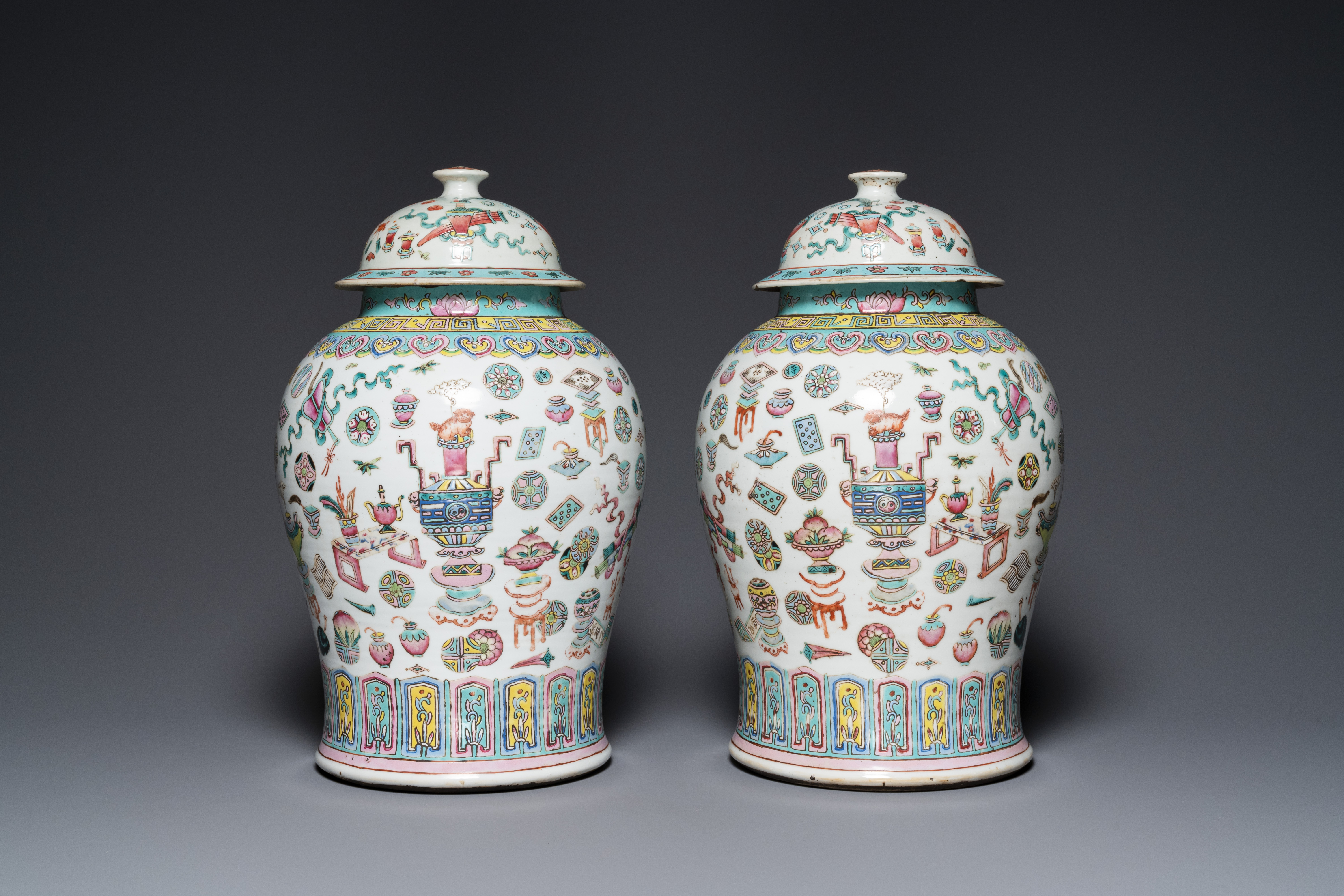 A pair of Chinese famille rose 'antiquities' vases and covers, 19th C.