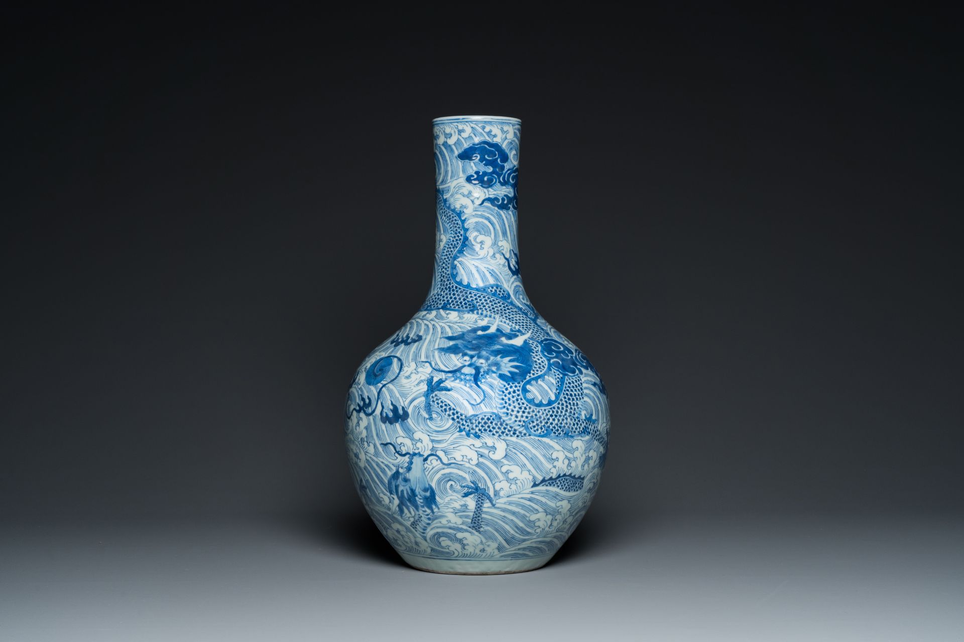 A Chinese blue and white 'dragons' bottle vase, 19th C.