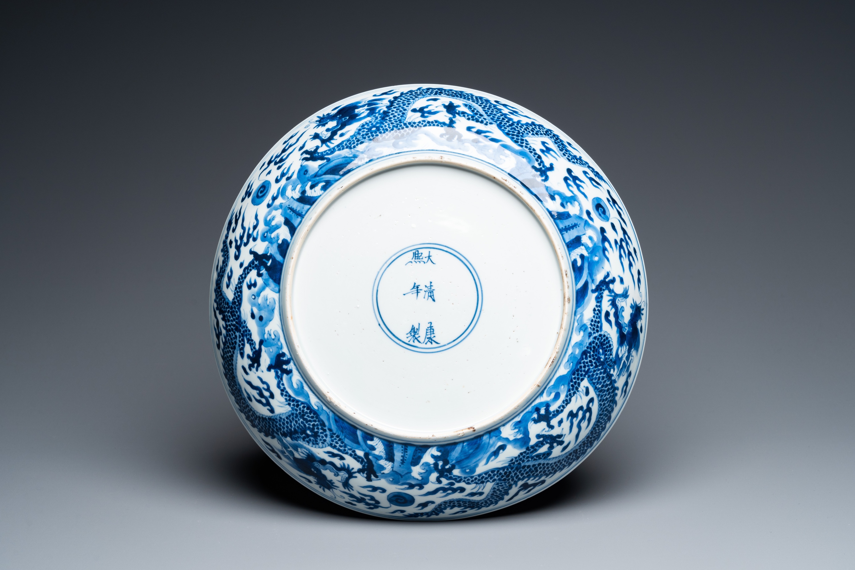 A Chinese blue and white 'dragon' dish, Kangxi mark and of the period - Image 2 of 18