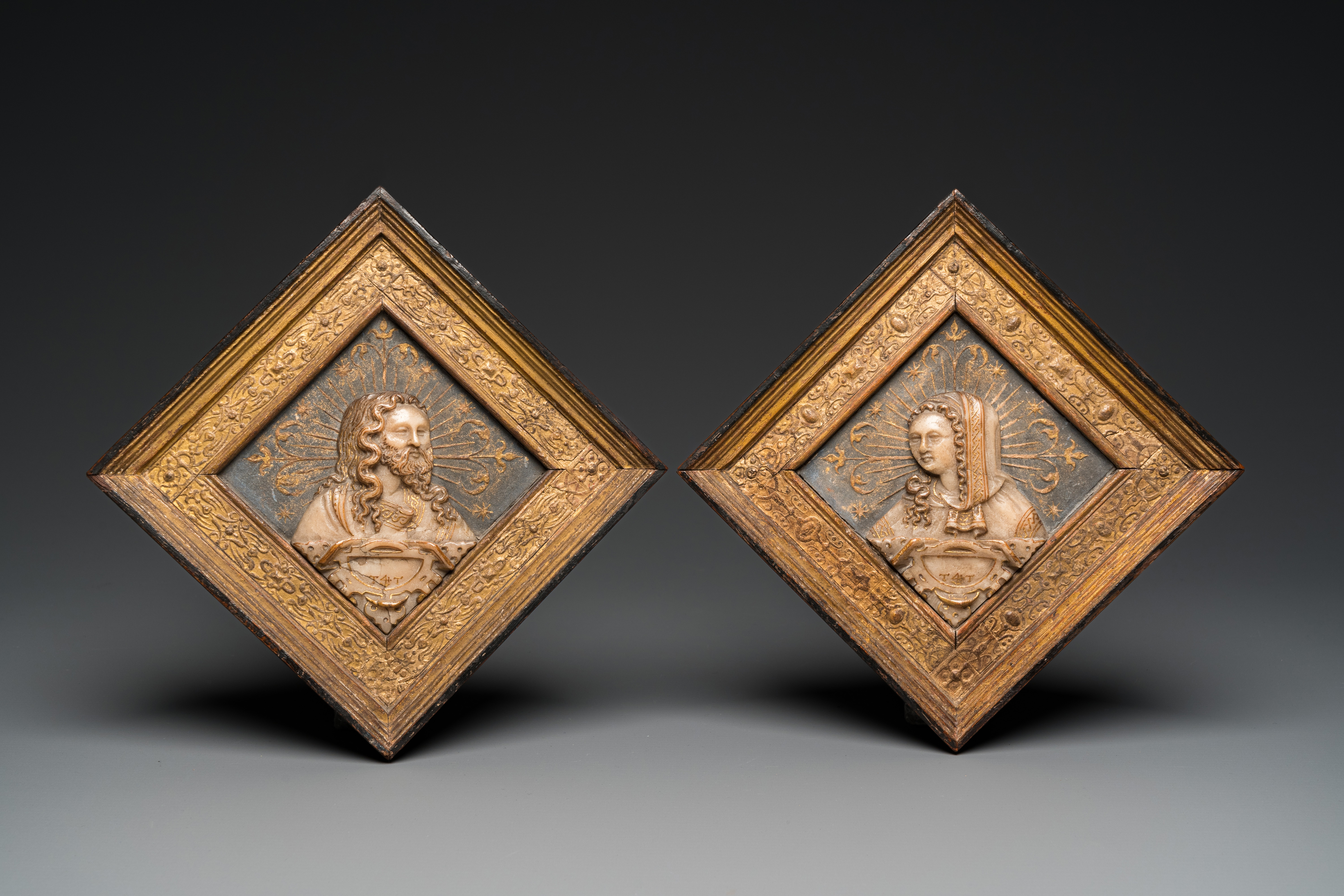 A pair of rare rhombus-shaped Malines alabaster portrait carvings, signed Tobias Tissenaken, end of