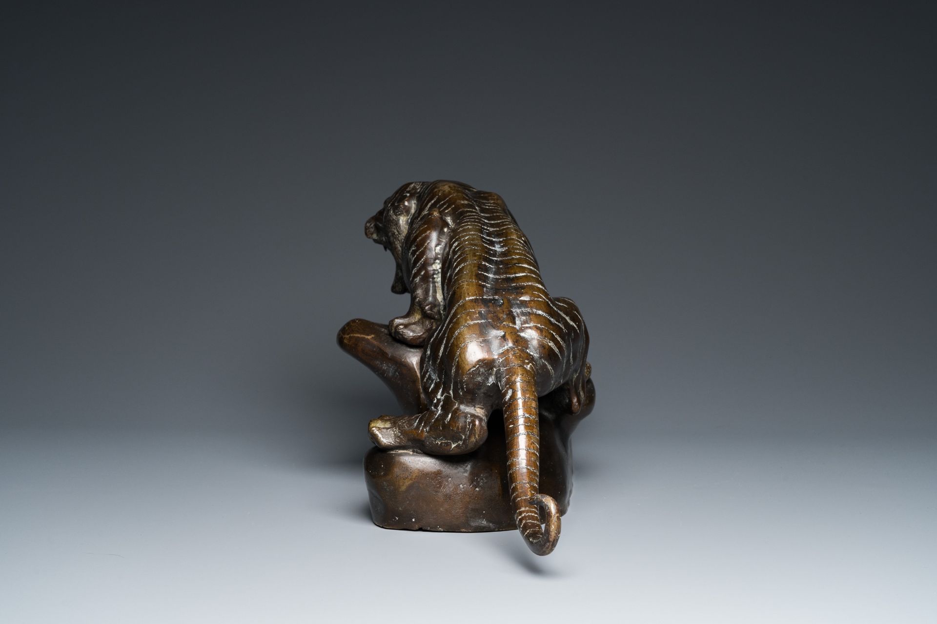 A large Vietnamese bronze tiger on a carved wooden stand, 19/20th C. - Image 6 of 10
