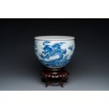A Chinese blue and white 'dragons and carps' jardinire on wooden stand, 19/20th C.
