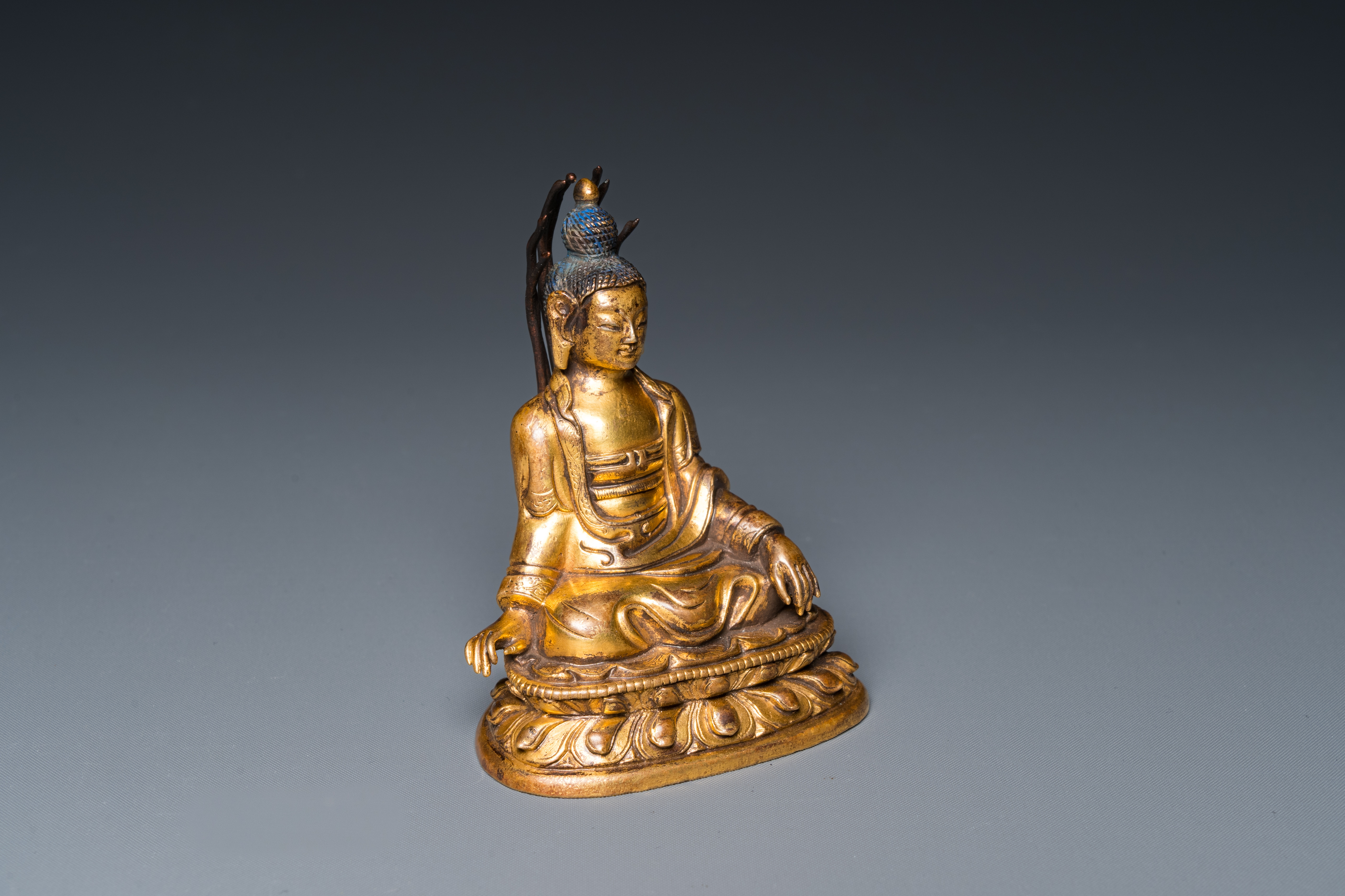 A small Sino-Tibetan gilt bronze Buddha, 19th C.