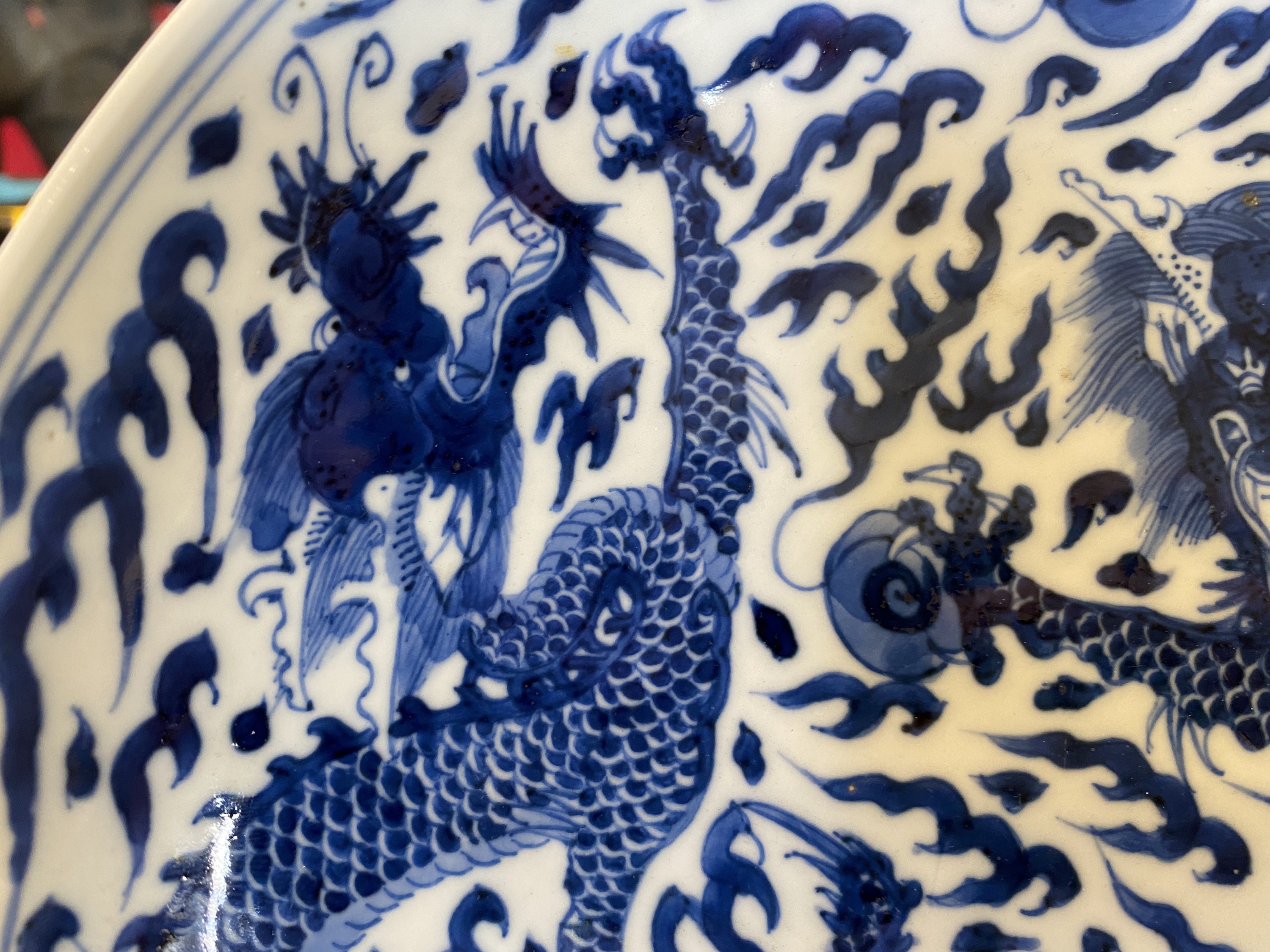 A Chinese blue and white 'dragon' dish, Kangxi mark and of the period - Image 5 of 18