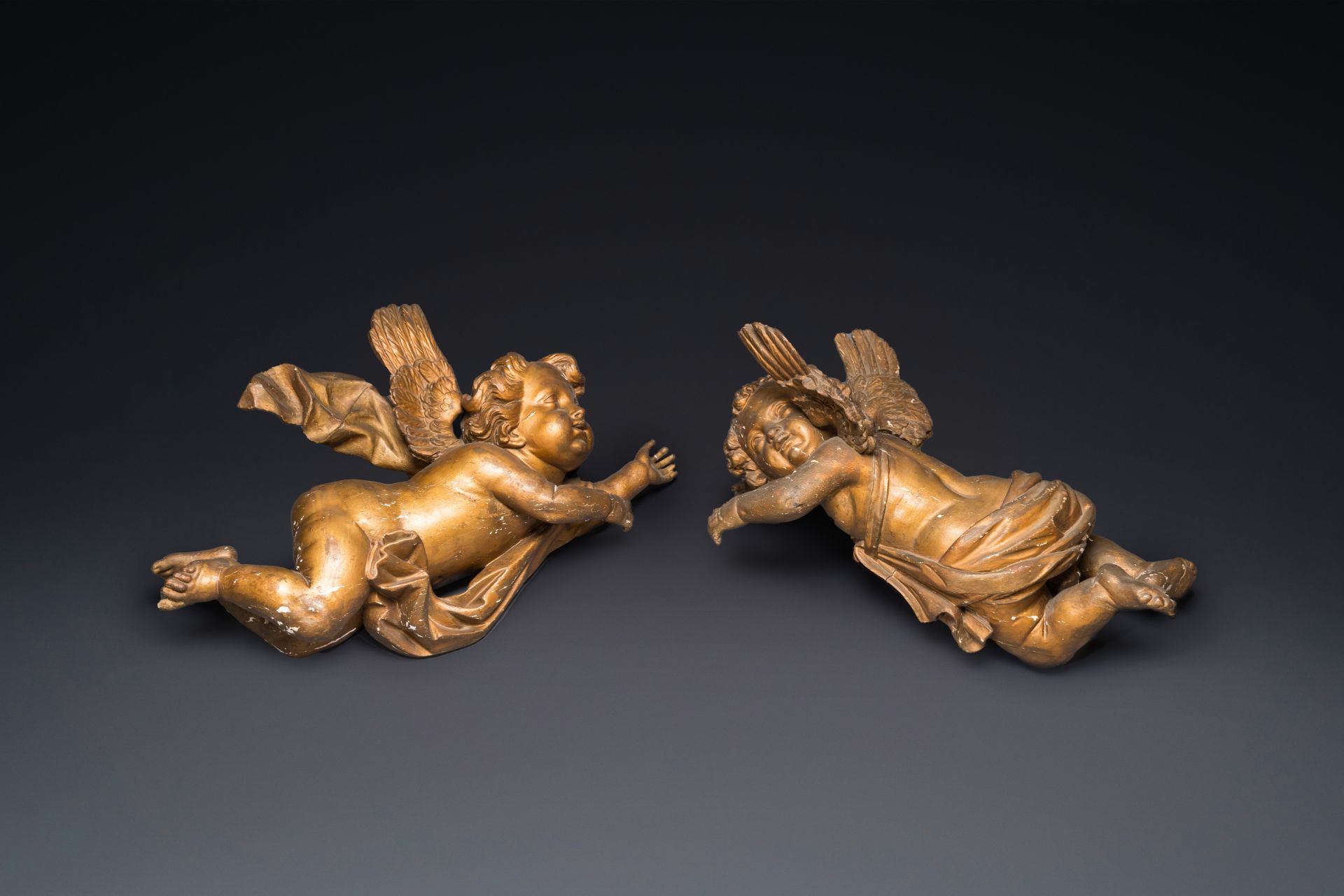 A pair of gilded wooden winged cherubs, probably Flanders, 1st half 18th C.