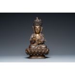 A Chinese partly gilt bronze figure of Guanyin on a lotus throne, Ming