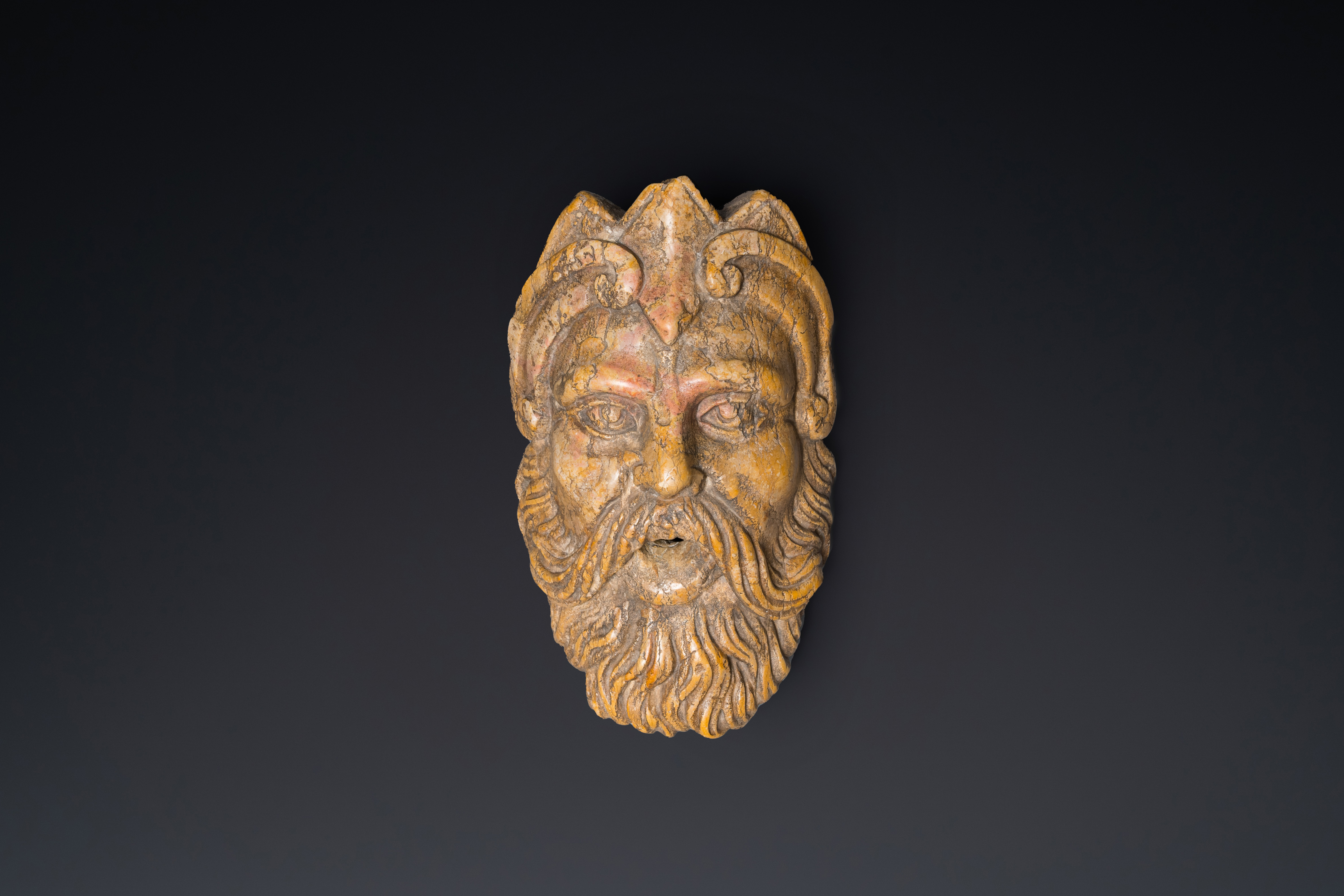 An Italian red marble 'Neptune' fountain head, 17/18th C.