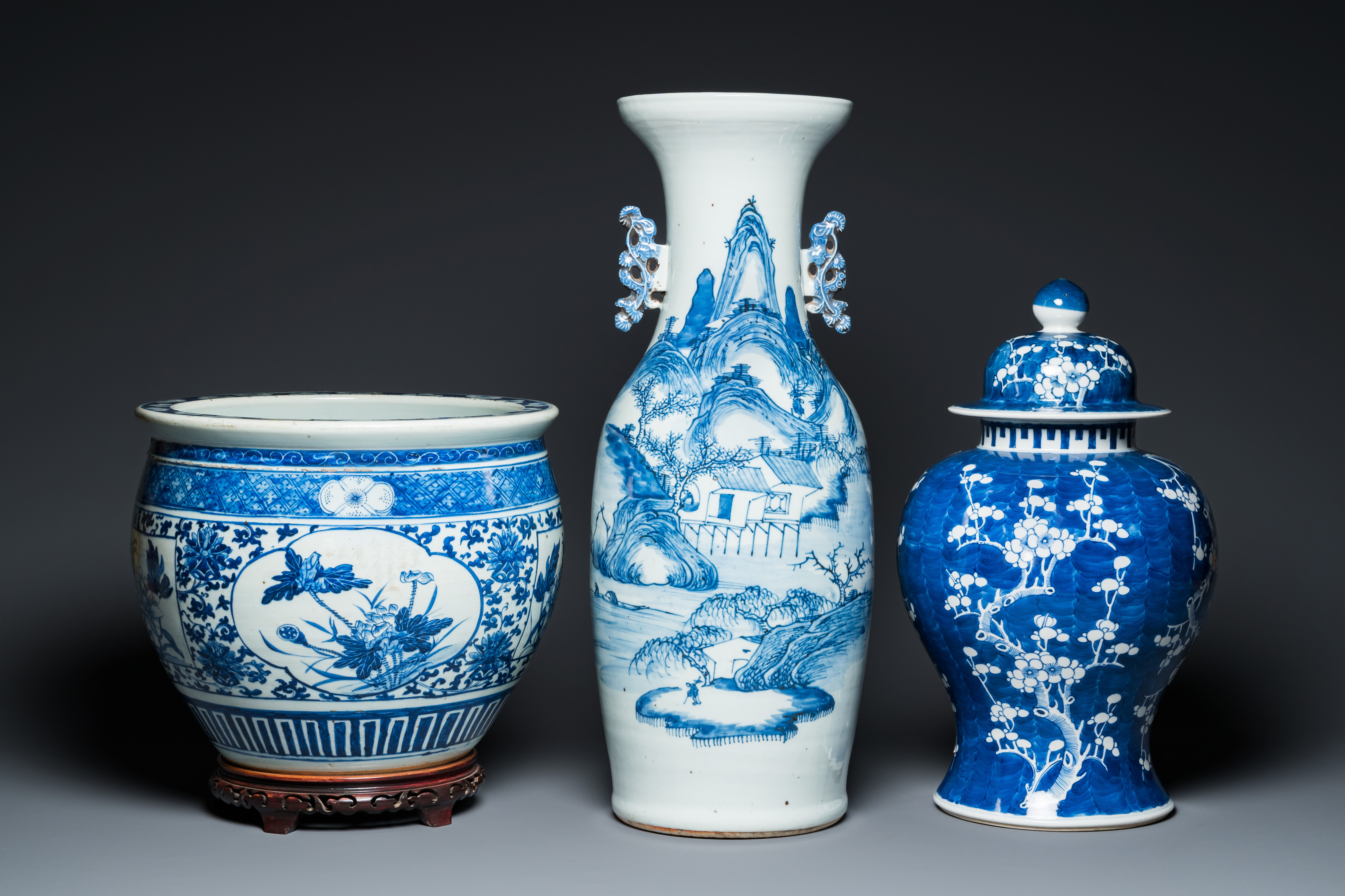 A Chinese blue and white 'landscape' vase, a covered vase and a jardiniere, 19th C.