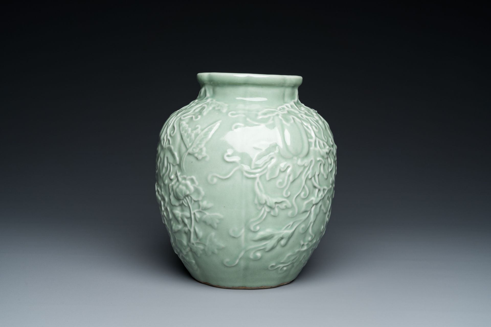 A Chinese relief-molded monochrome celadon-glazed vase, 19/20th C. - Image 2 of 6