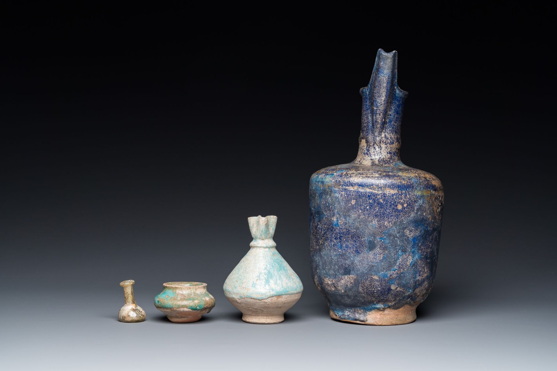 Three blue- and turquoise-glazed Islamic pottery wares and a glass bottle, Kashan and Raqqa, 12th C. - Image 5 of 7