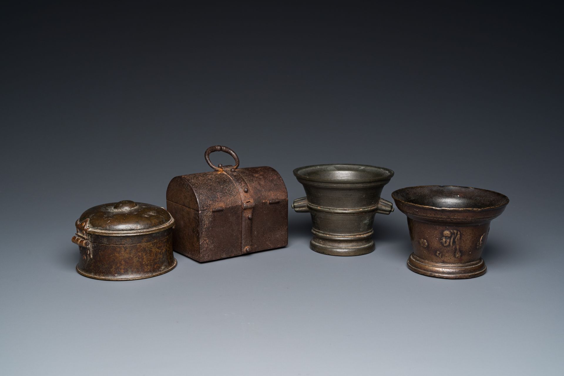 Two bronze mortars, a round lidded box and an iron casket, Western Europe, 16/17th C.