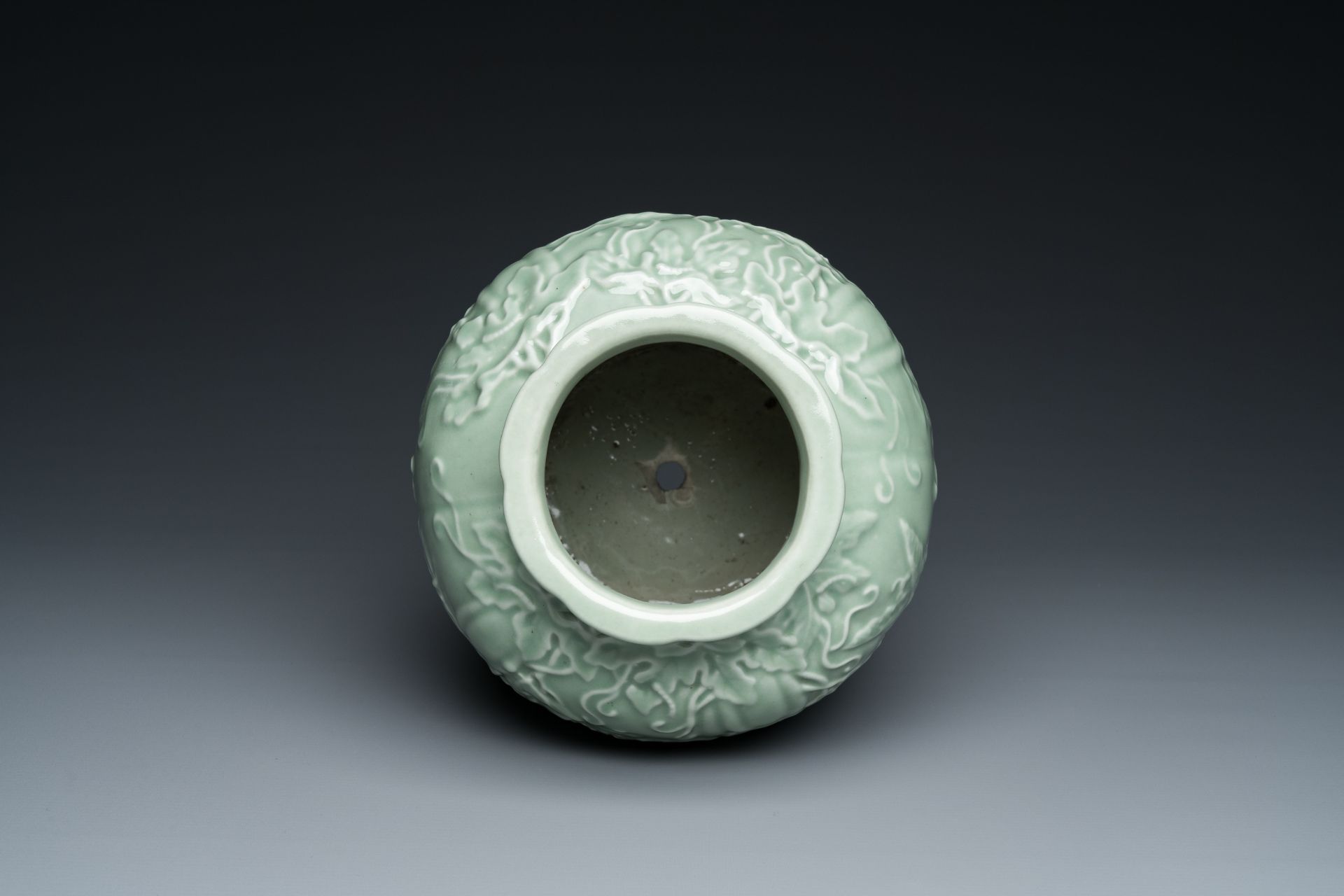 A Chinese relief-molded monochrome celadon-glazed vase, 19/20th C. - Image 5 of 6