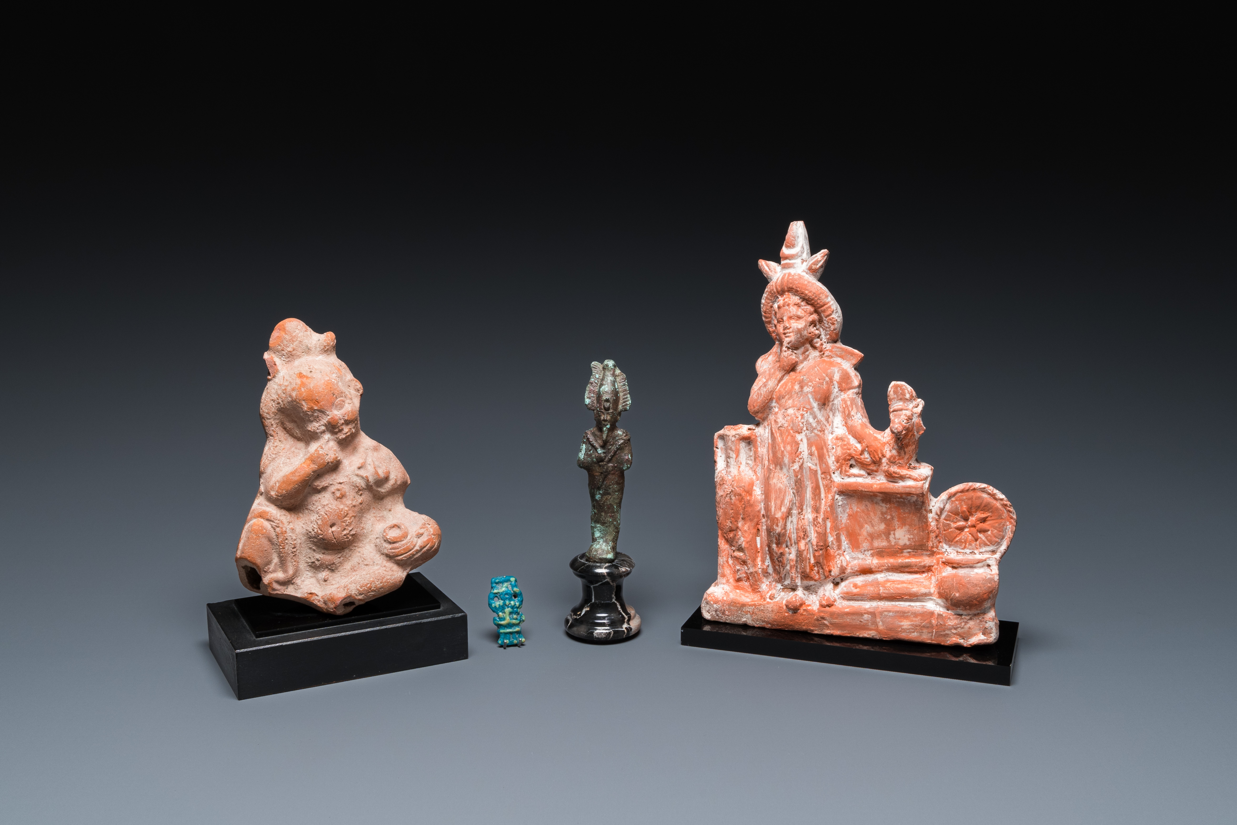 Two Egyptian terracotta sculptures, a bronze sculpture of Osiris and a turquoise frit amulet, Late p