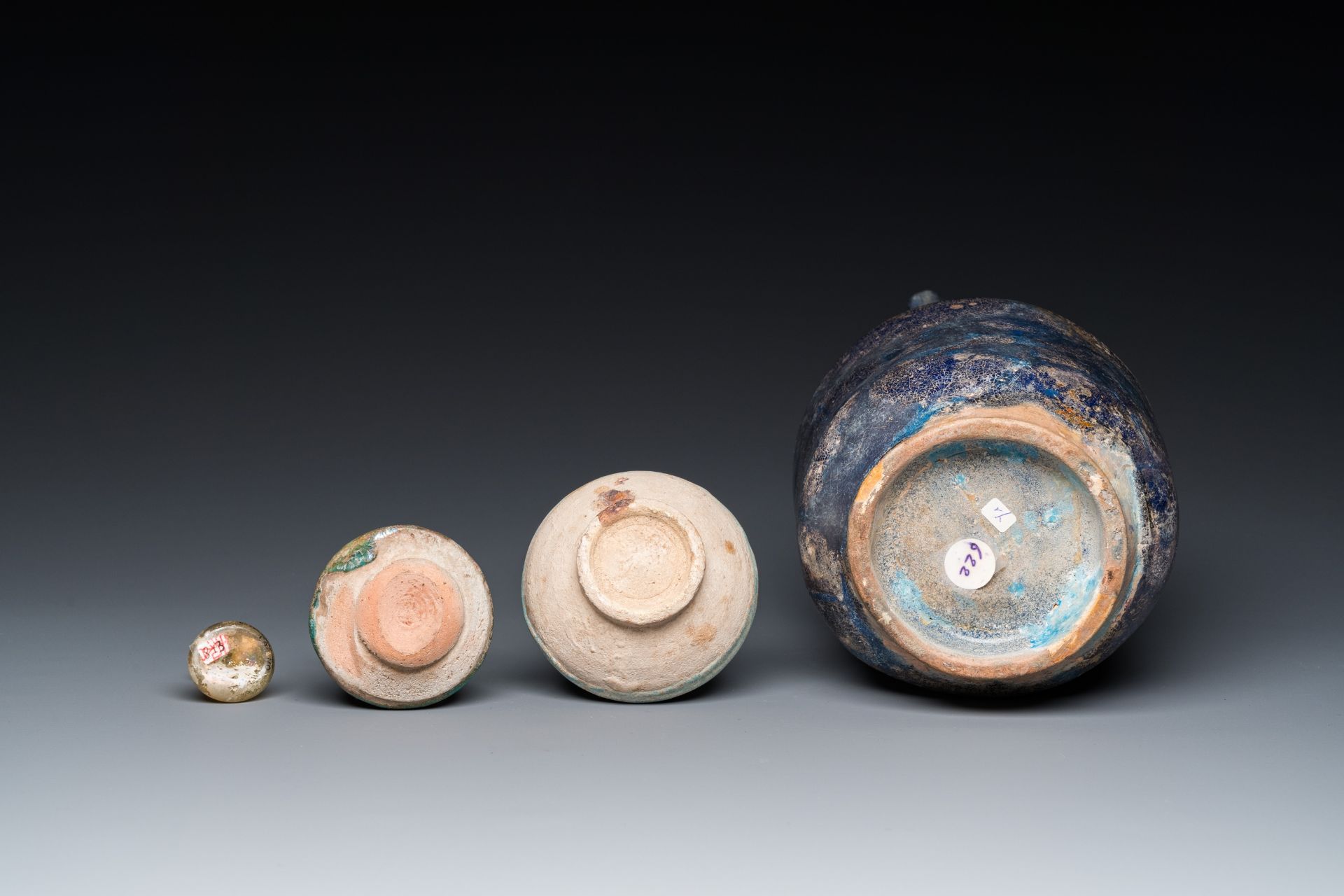 Three blue- and turquoise-glazed Islamic pottery wares and a glass bottle, Kashan and Raqqa, 12th C. - Image 7 of 7