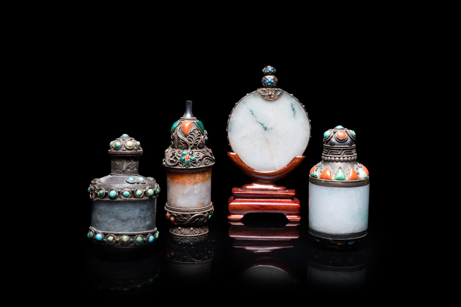 Four Chinese inlaid silver-mounted jade snuff bottles, 19/20th C.