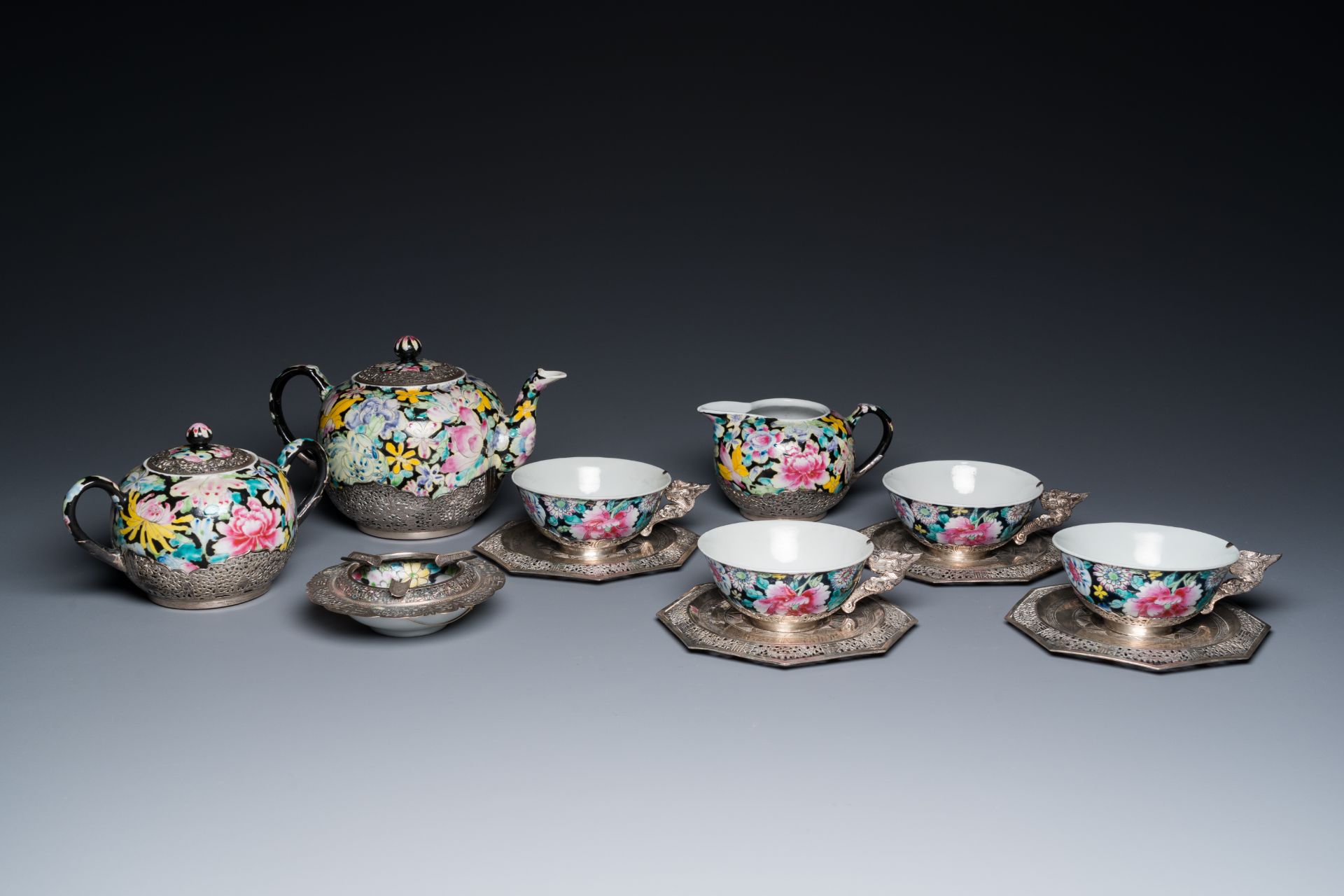 A Chinese eight-piece silver-mounted famille rose millefleurs tea service, Qianlong mark 20th C.