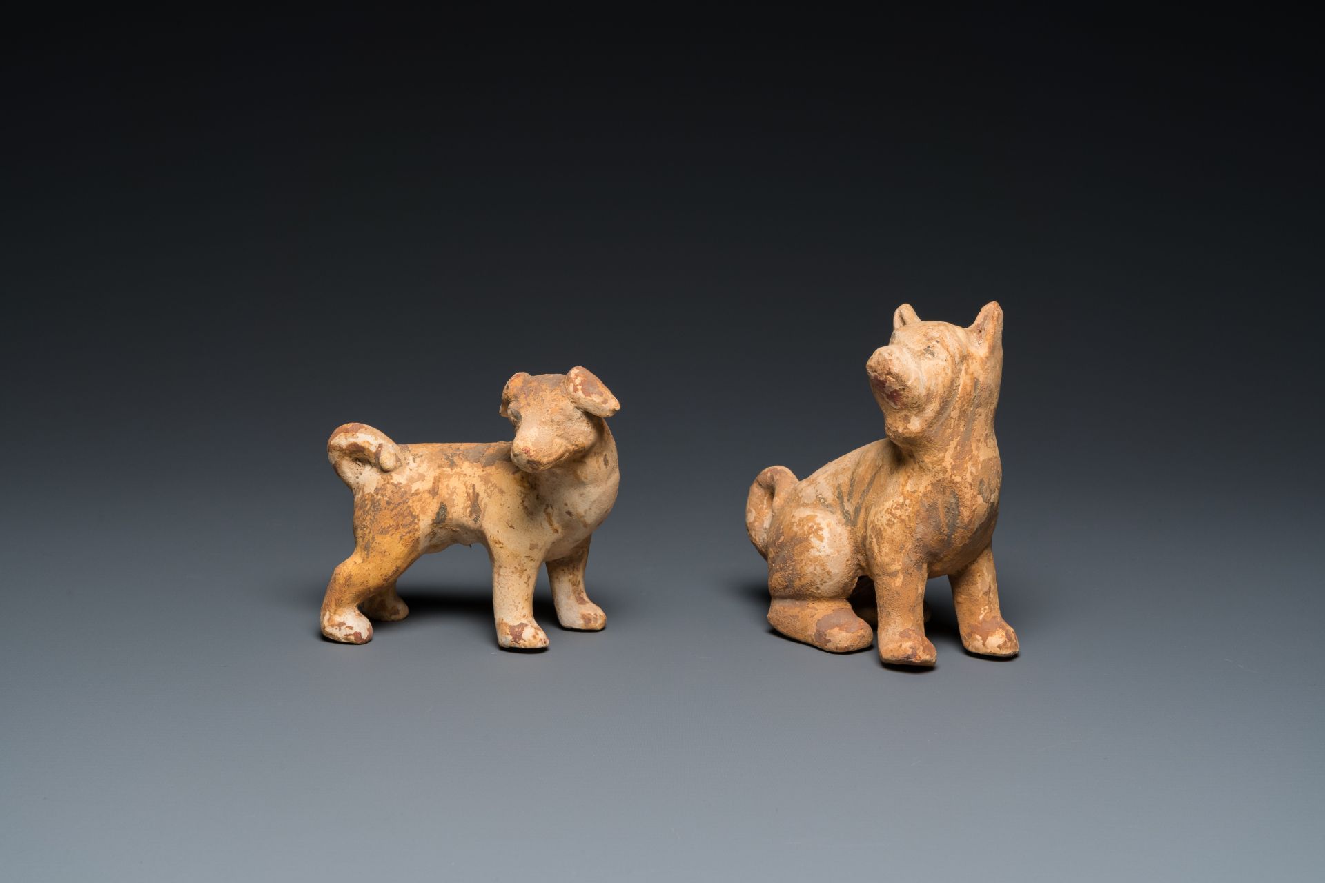 Two Chinese 'mingqi' painted pottery models of dogs, Han