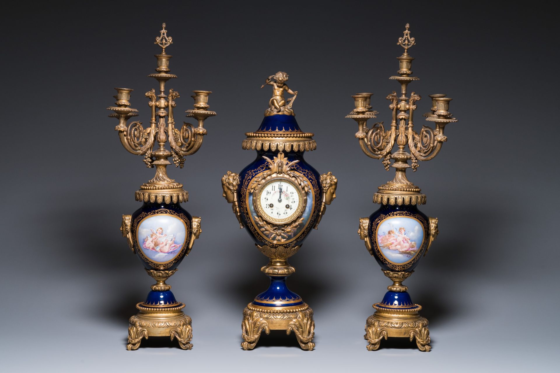 A large three-piece Sevres-style clock garniture with gilt bronze mounts, France, 19th C.