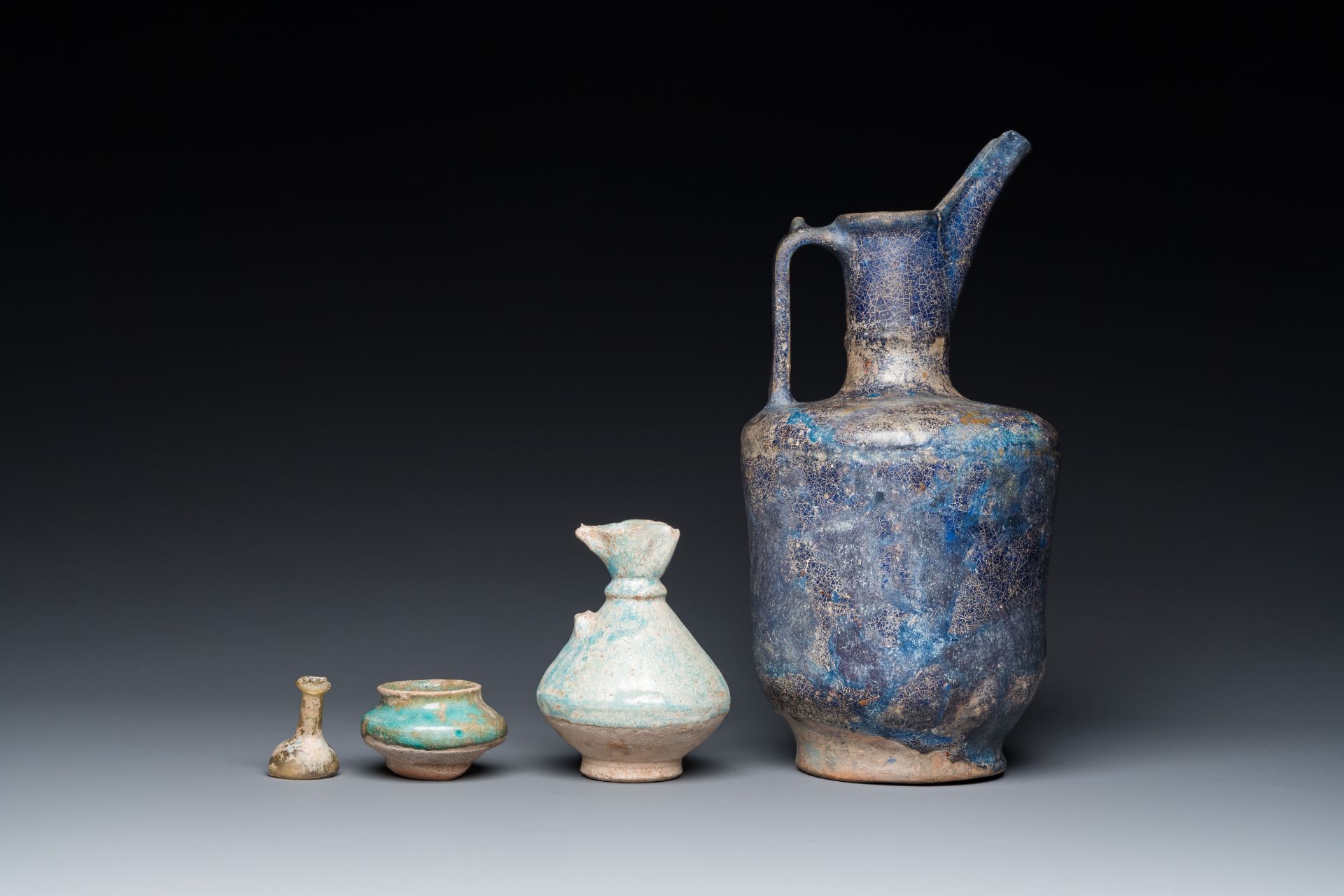 Three blue- and turquoise-glazed Islamic pottery wares and a glass bottle, Kashan and Raqqa, 12th C. - Image 4 of 7