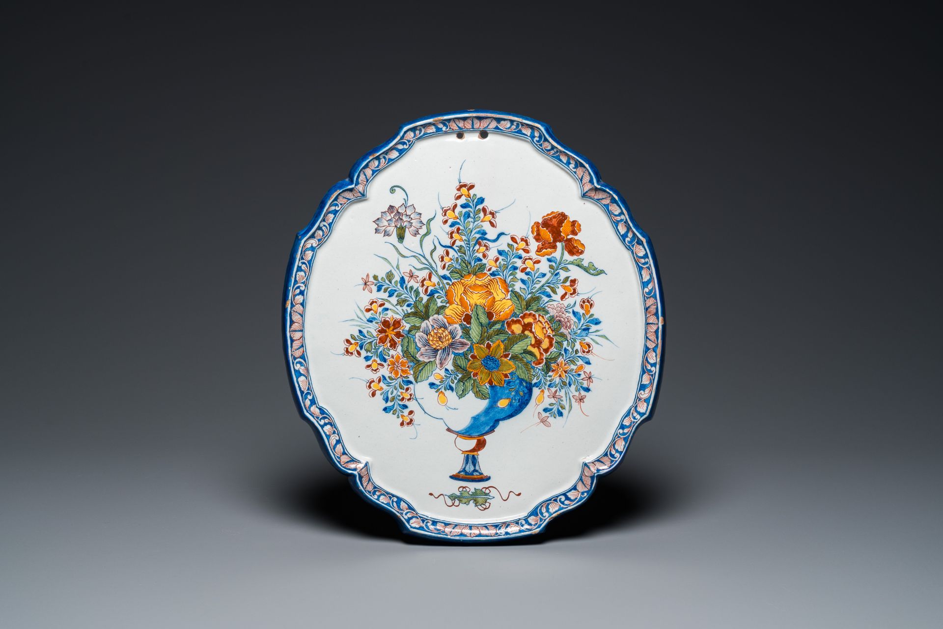 A fine polychrome Dutch Delft 'flower vase' plaque, 18th C.