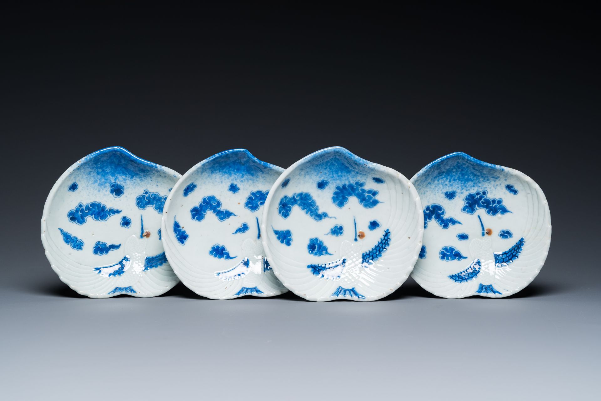 Four Japanese blue and white peach-shaped 'crane' dishes standing on three feet, Edo, 18/19th C.