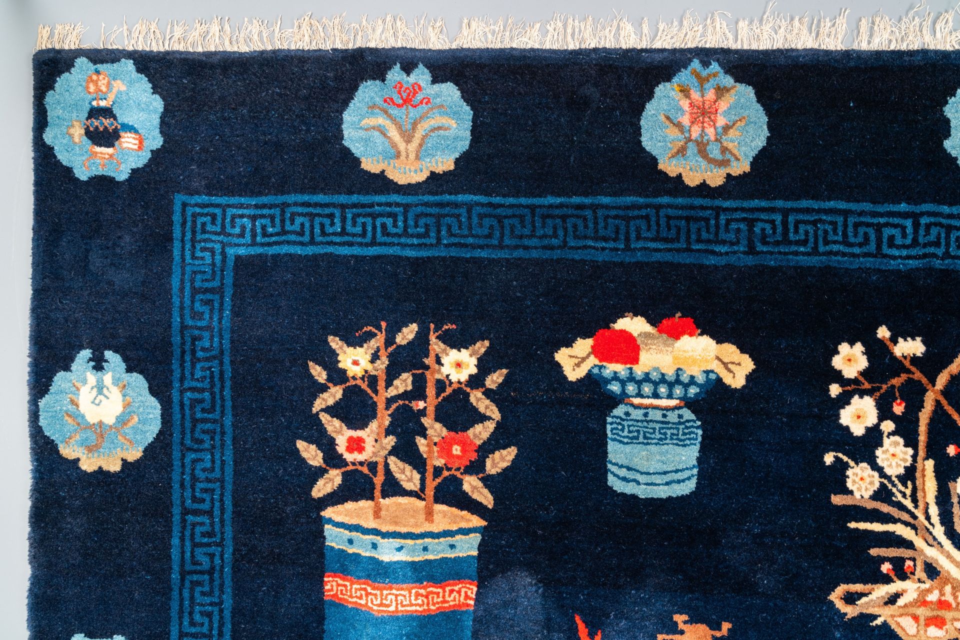 A large Chinese blue-ground 'antiquities' rug, 19th C. - Image 2 of 6