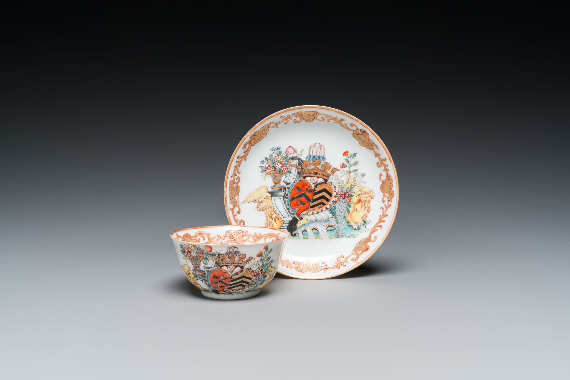 A Chinese Dutch market famille rose cup and saucer with the arms of van Isselmuden and van Haersolte