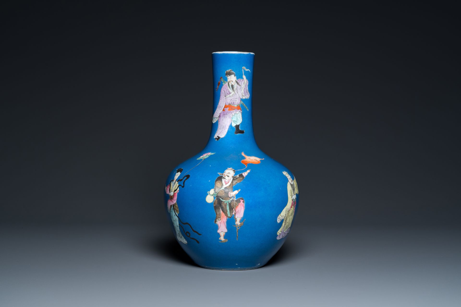 A Chinese blue-ground famille rose 'eight immortals' bottle vase, Qianlong mark, 19th C.