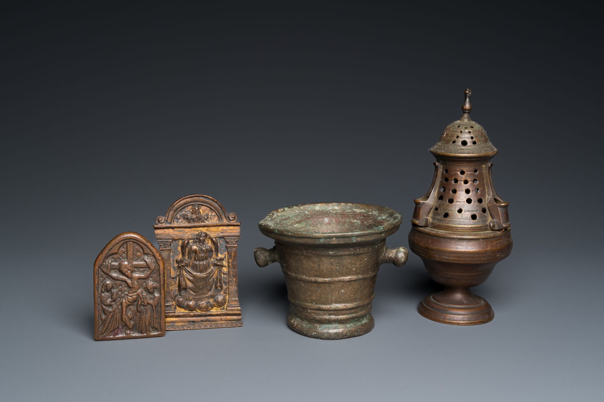 A bronze mortar, a censer and two pax of which one gilded, Western Europe, 16/17th C.