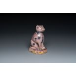 A manganese faience model of a cat, probably northern France, dated 1709