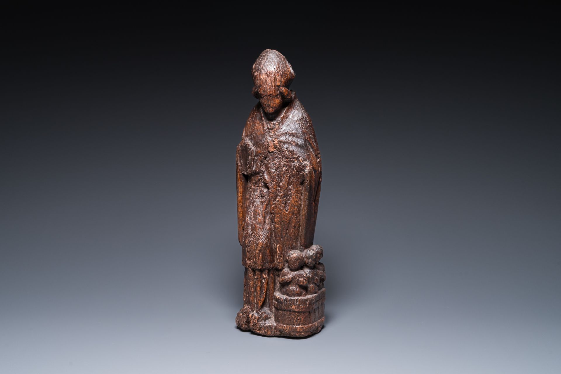 A Flemish carved oak sculpture of Saint Nicolas and the three boys in the salting-tub, 16th C.