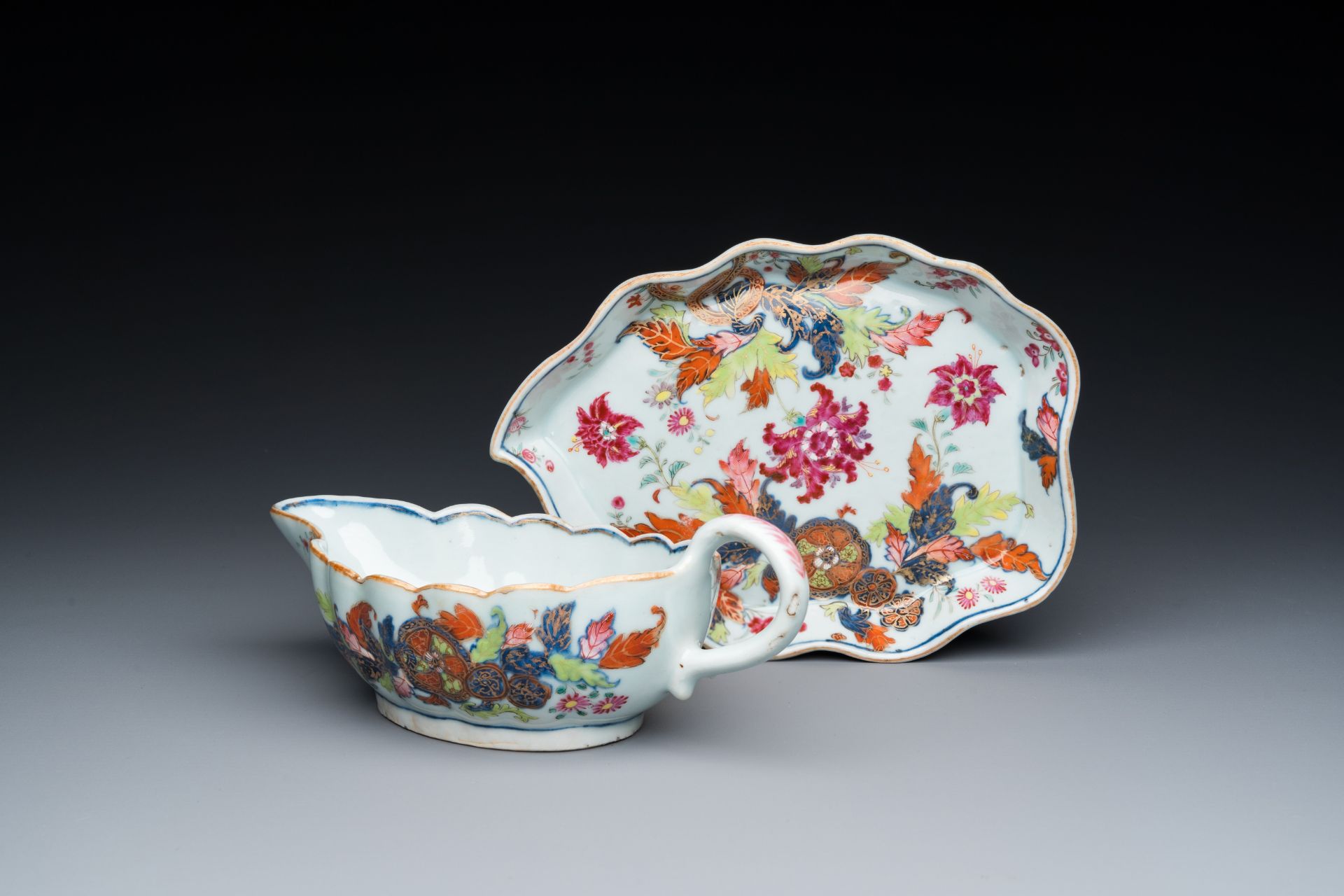 A Chinese famille rose 'pseudo-tobacco leaf' sauce boat on stand, Qianlong