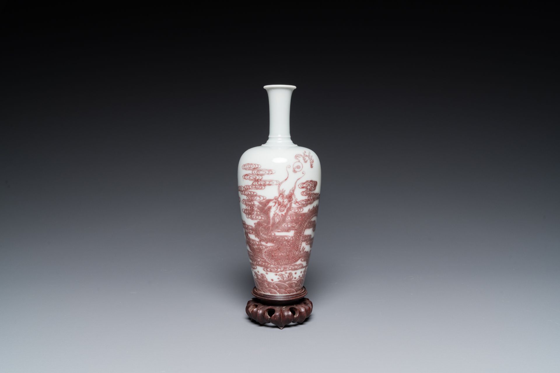 A Chinese copper-red 'dragon' vase on wooden stand, Kangxi mark, 19/20th C.