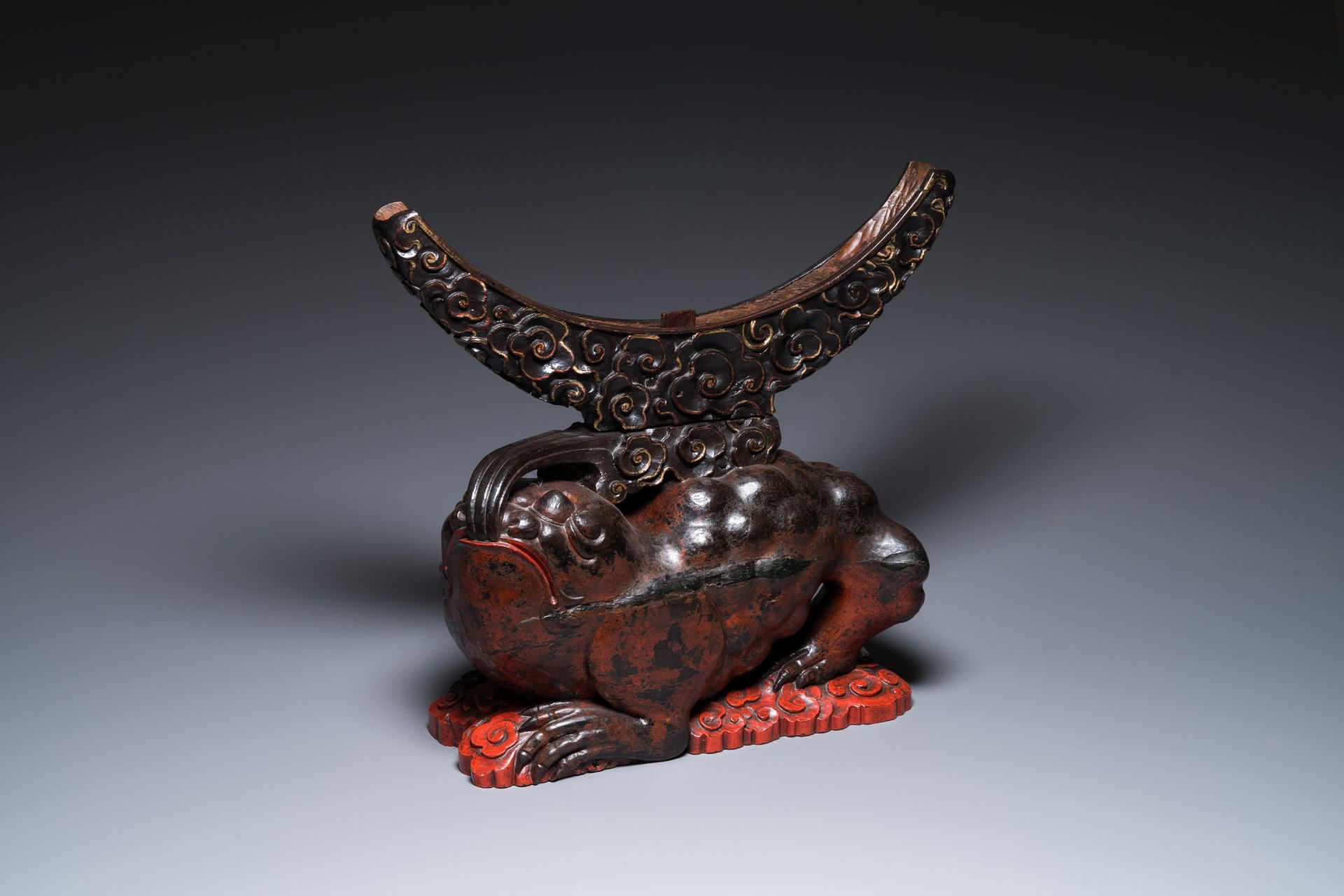 A large Chinese lacquered wooden stand in the shape of a three-legged toad, Ming