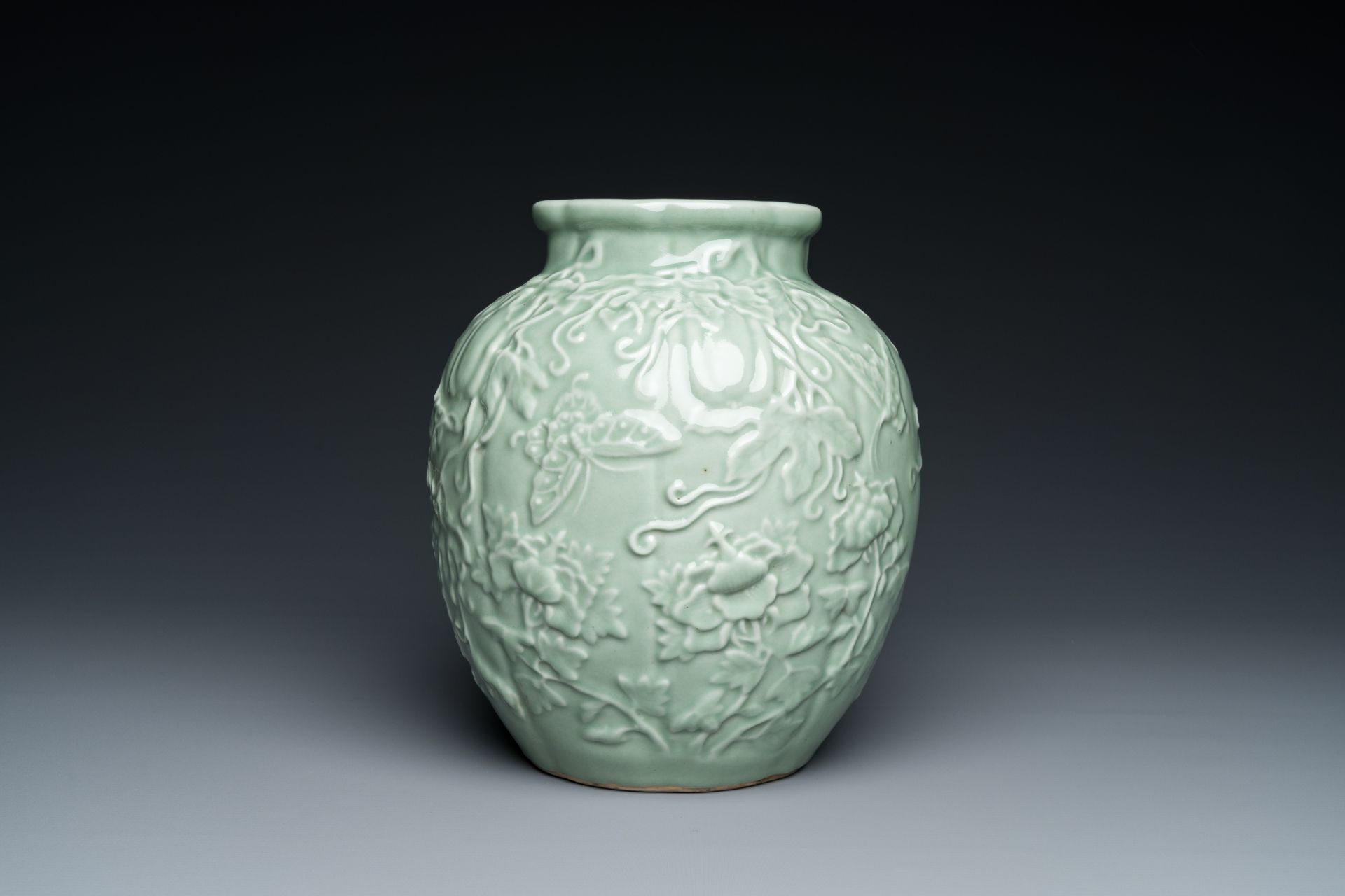 A Chinese relief-molded monochrome celadon-glazed vase, 19/20th C.