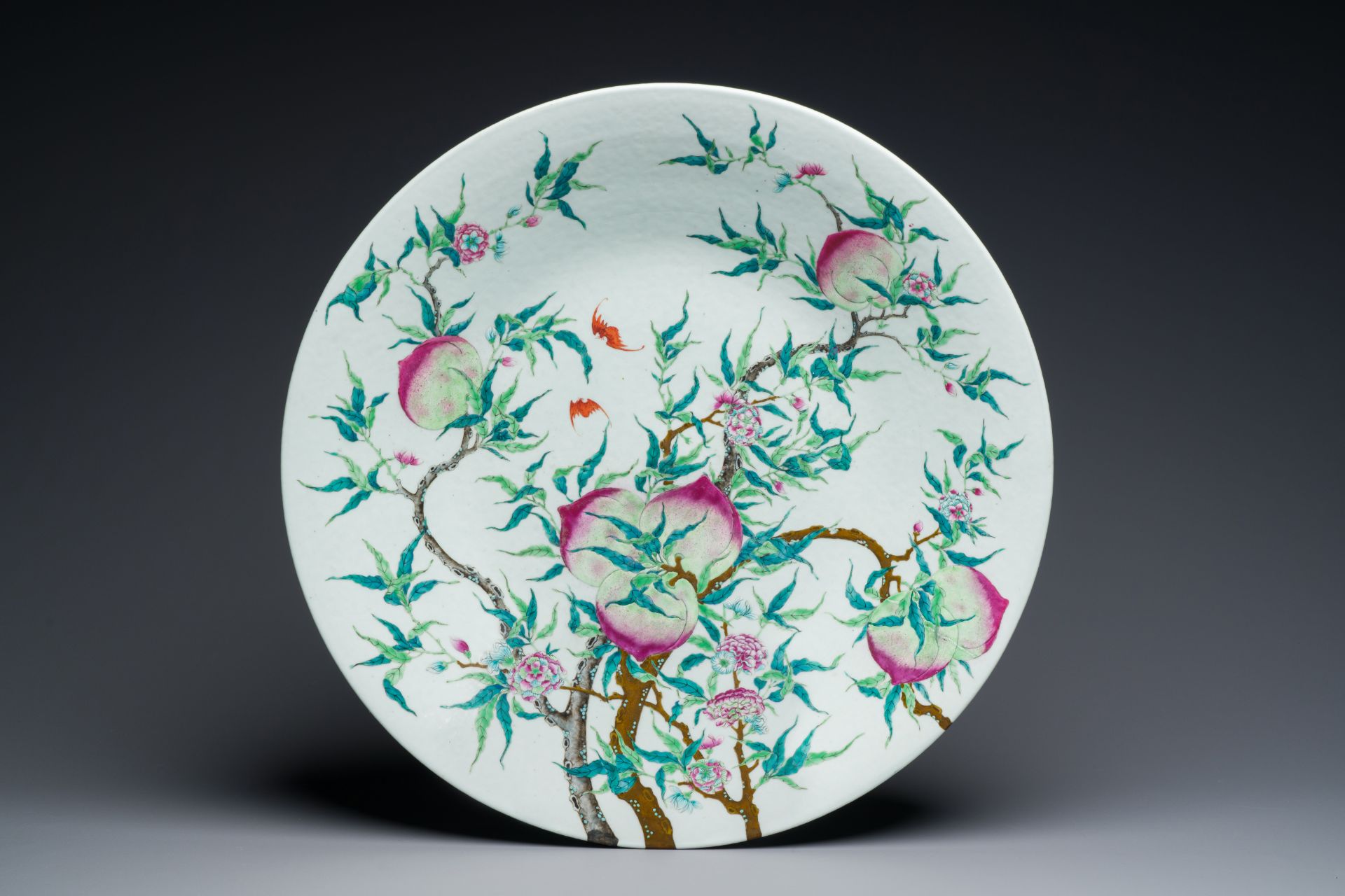 A fine and large Chinese famille rose 'nine peaches' dish, Qianlong mark, 19th C.