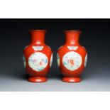 A pair of Chinese coral-ground famille rose vases with medallions showing playing boys, 18/19th C.