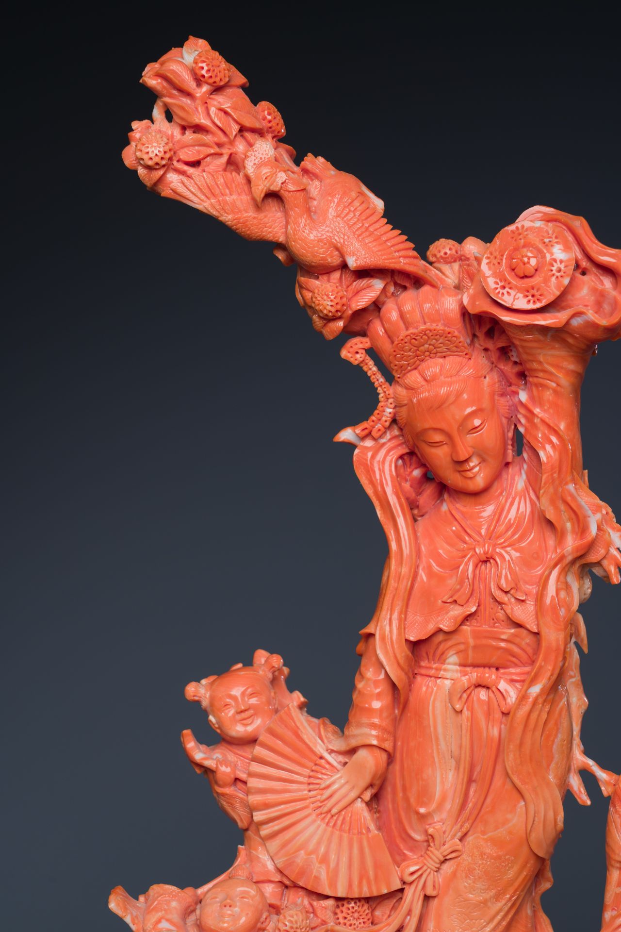 A large Chinese red coral group of a lady holding a cornucopia surrounded by children, 19/20th C. - Image 7 of 8